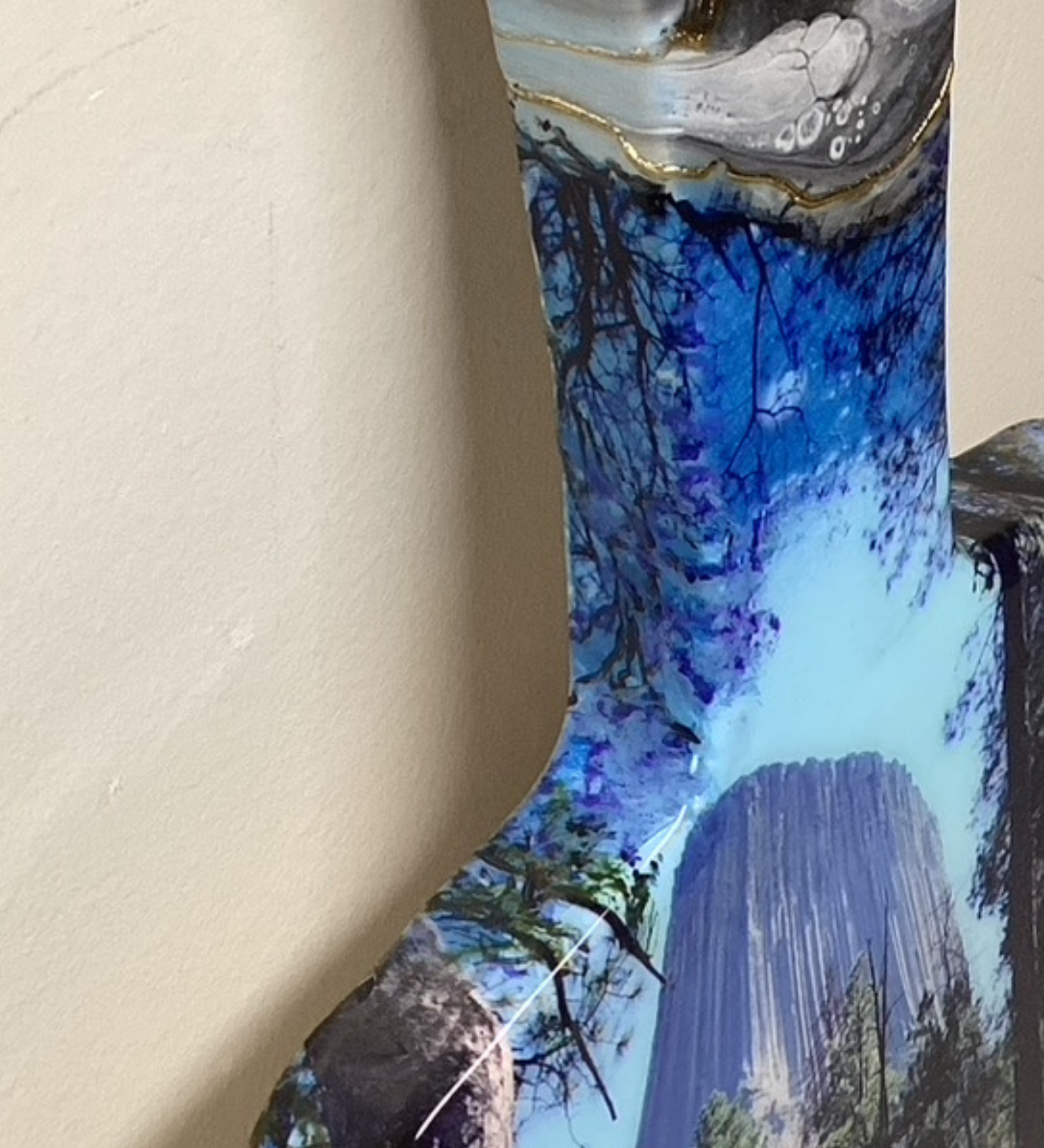 Handcrafted devils tower Wyoming charcuterie board with black and blue resin artwork on maple hardwood serving board.