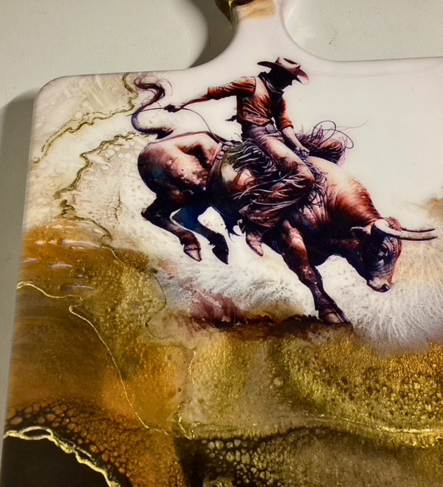 Handmade western charcuterie board featuring bull rider artwork with gold resin accents on natural wood