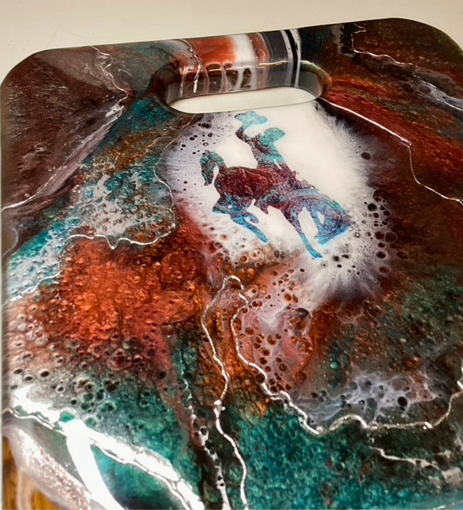 Handmade teak charcuterie board with Wyoming Cowboy design, copper and teal resin artwork, and 24K gold accents