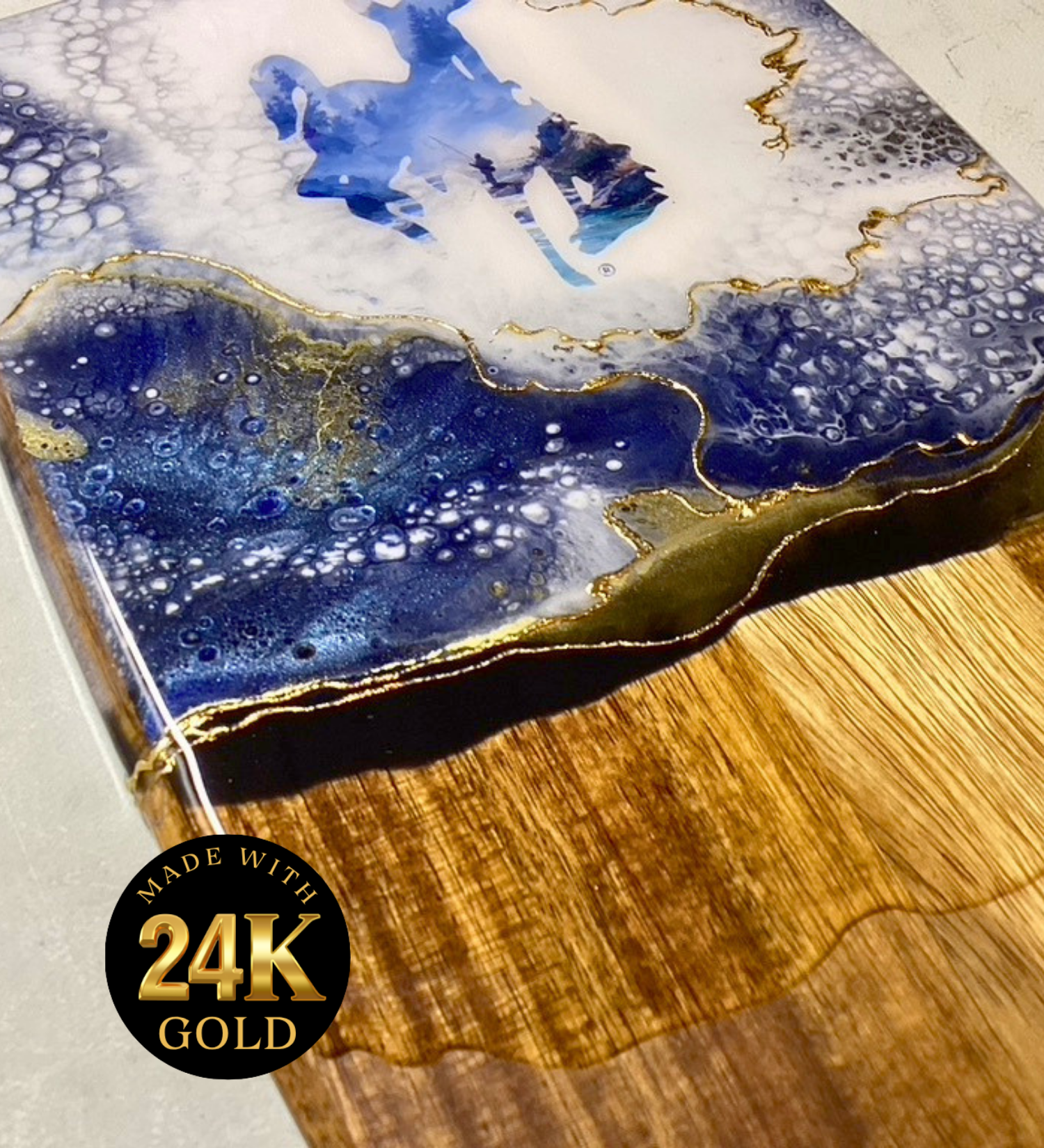 Handmade Wyoming charcuterie board with fly fisherman scene, resin art, and 24K gold accents on acacia wood