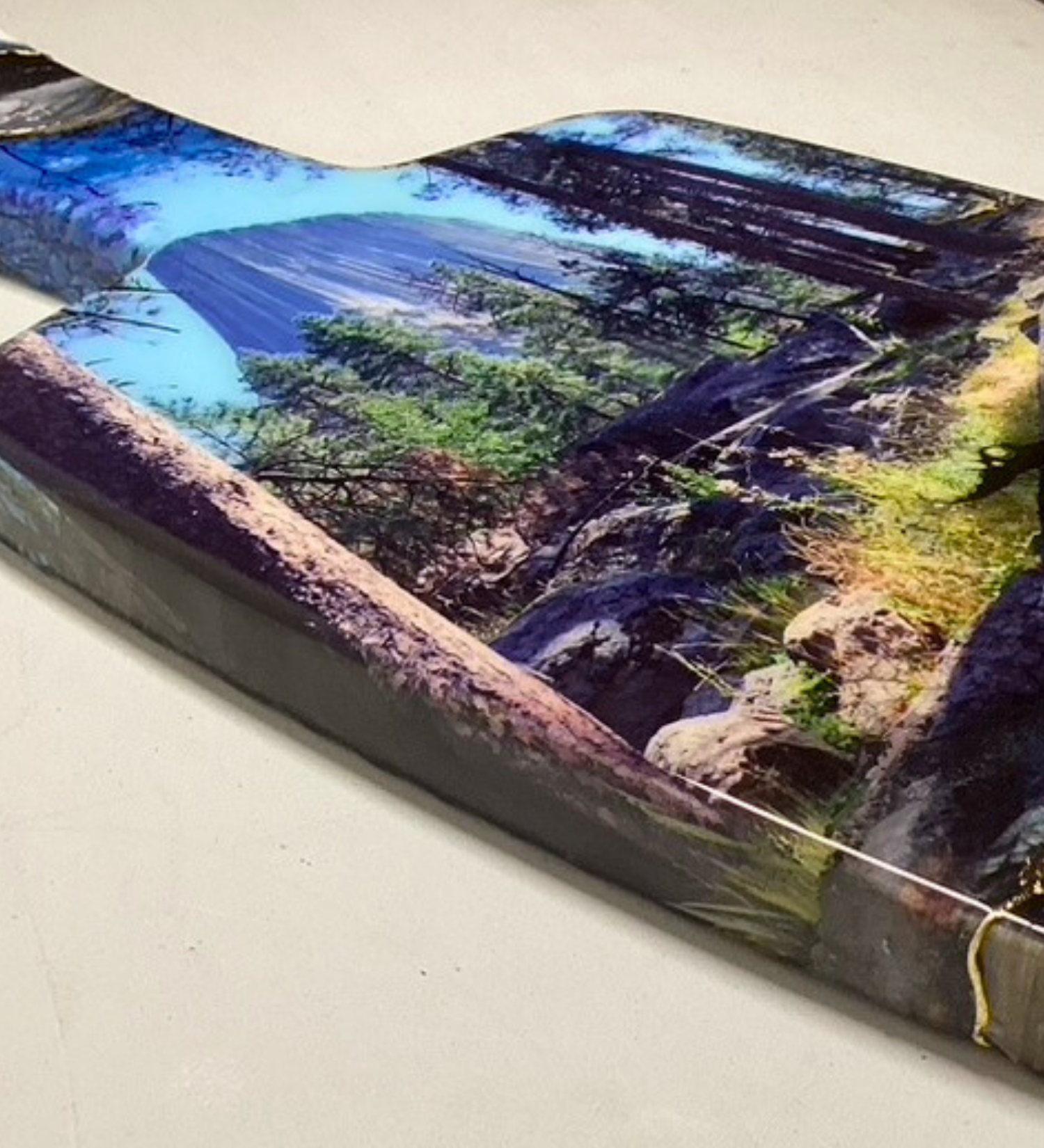 Handcrafted devils tower Wyoming charcuterie board with black and blue resin artwork on maple hardwood serving board.