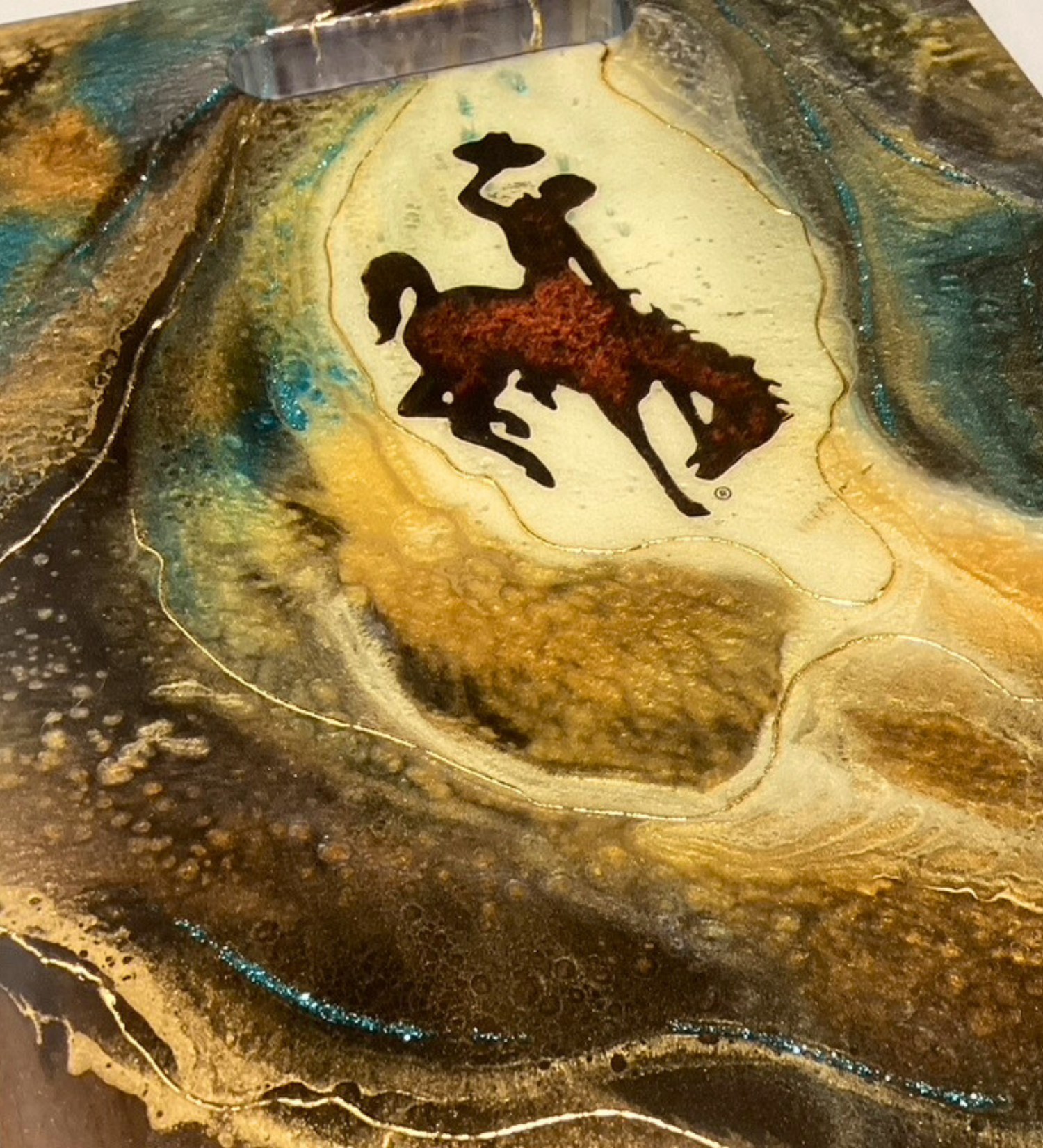 Handcrafted Wyoming cowboy charcuterie board featuring flowing resin art on walnut hardwood.