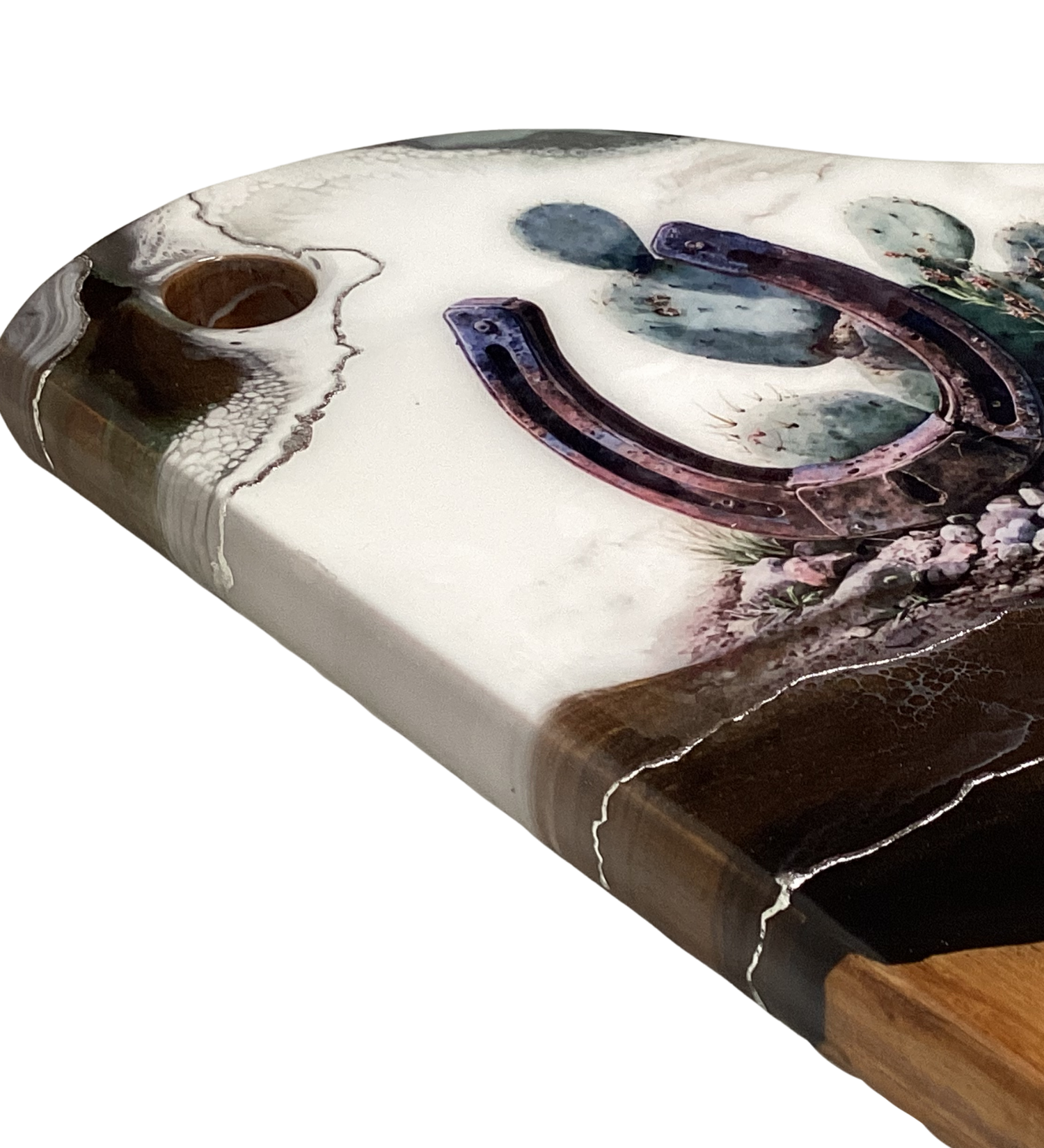 Handcrafted acacia charcuterie board featuring a rustic horseshoe standing upright with cactus behind it, accented with pure silver, Western décor style.