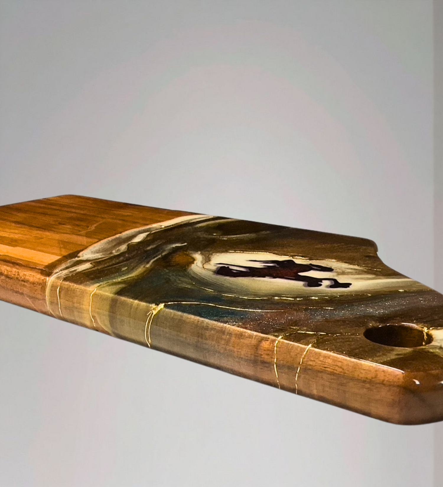 Handmade acacia wood charcuterie board with bucking horse design, resin art, and 24K gold accents inspired by Wyoming western heritage