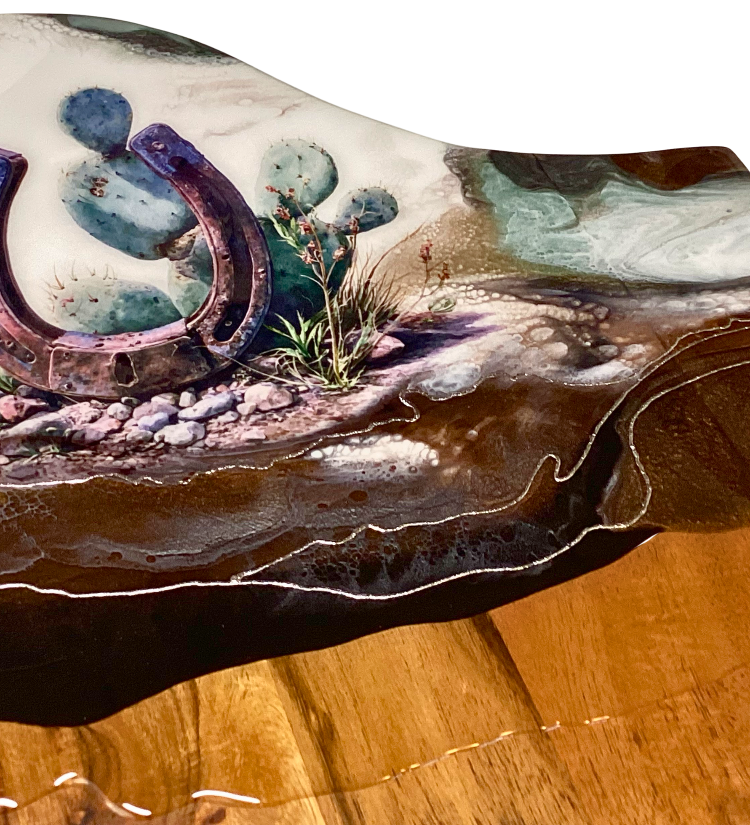 Handcrafted acacia charcuterie board featuring a rustic horseshoe standing upright with cactus behind it, accented with pure silver, Western décor style.