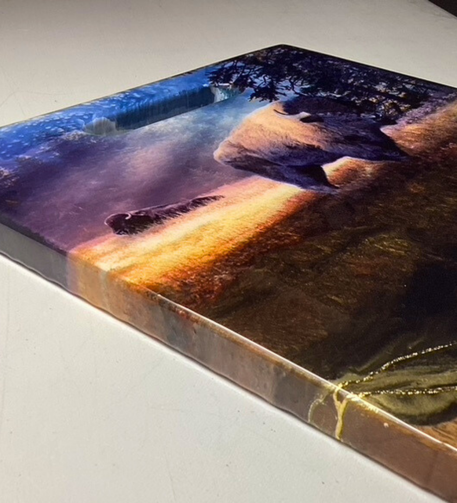 One-of-a-kind walnut charcuterie board featuring a bison prairie scene with hand-painted resin artwork and 24K gold accents. Functional Western art for entertaining.