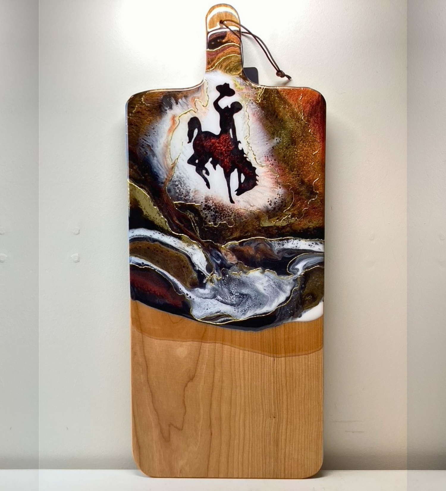 Handmade Wyoming Cowboy charcuterie board with resin art and 24K gold accents. A one-of-a-kind serving piece that doubles as Western wall art.