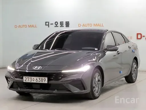 A black Hyundai sedan parked in a showroom with a white background and signage.