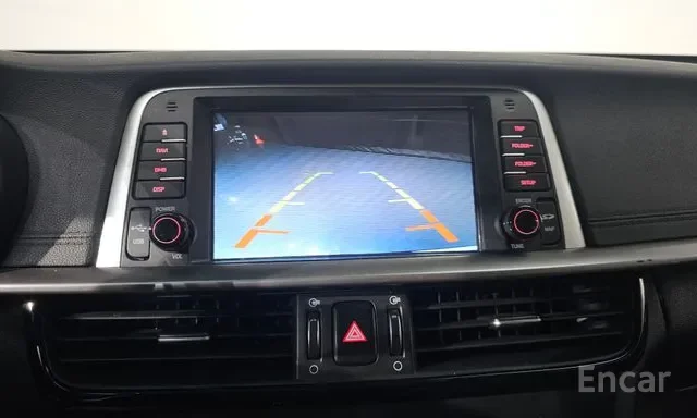 Car's dashboard display showing rearview camera with parking guidelines.