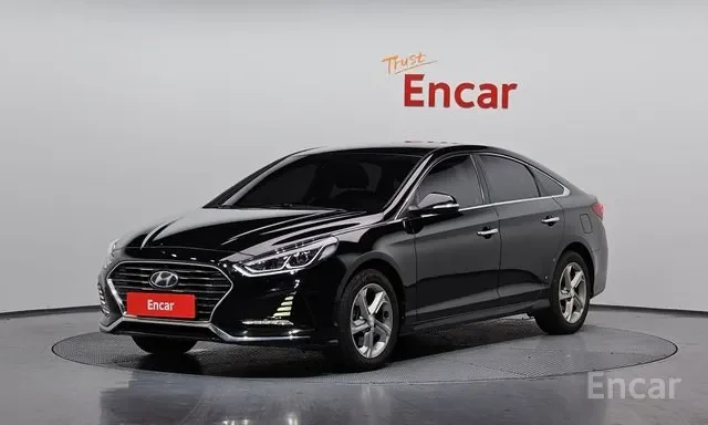 Black Hyundai sedan in a showroom with 'Encar' logo and 'Trust' written on the wall behind it.