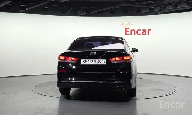 Black car with license plate 381하9891 parked in a white room with the words 'Trust Encar' on the wall.