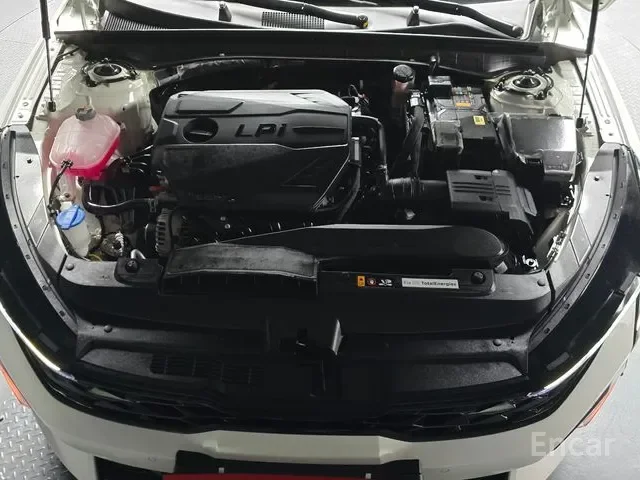 Car engine with labeled LP1 engine cover, coolant reservoir, fuse box, and other engine components.