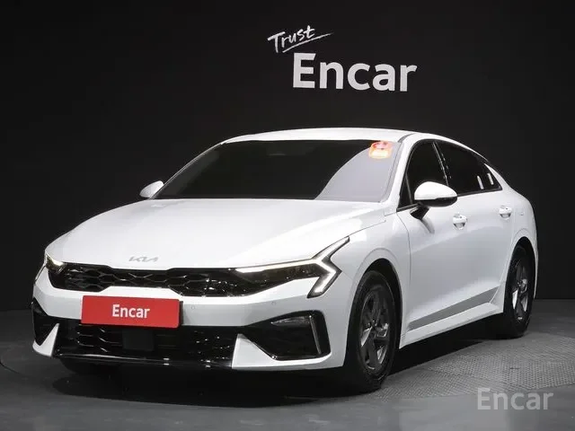 White sedan car on display at a dealership with 'Trust Encar' sign above it.