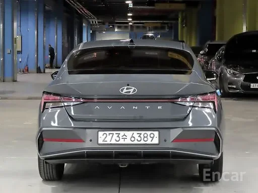 Rear view of a gray Hyundai Avante parked in an indoor parking garage.