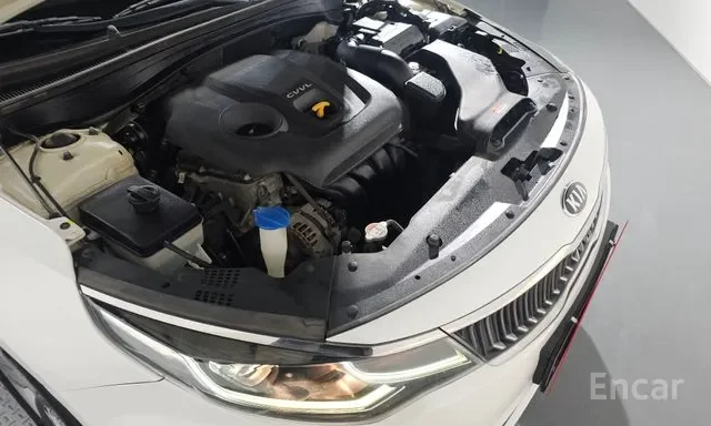 Front view of a car with the hood open, revealing the engine and engine bay components.