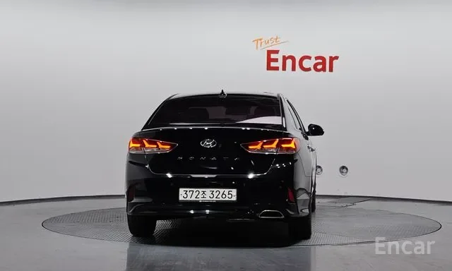 Black Hyundai sedan in a showroom with the words "Trust Encar" in red and orange above it.