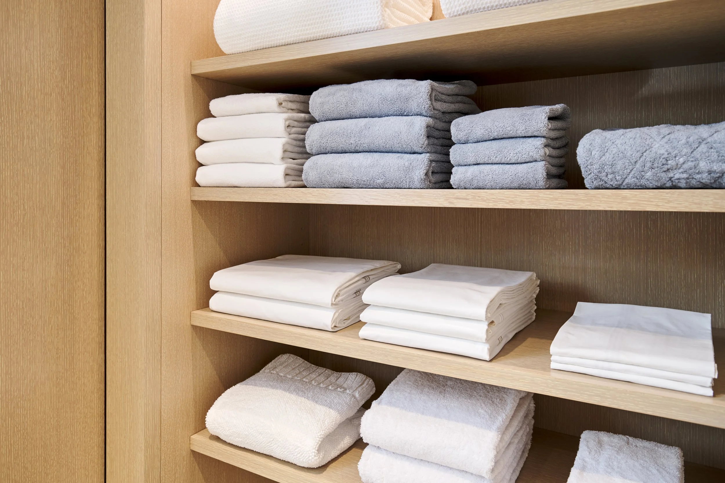 Luxury brand linens perfectly folded in a handmade closet on the Upper East Side of Manhattan