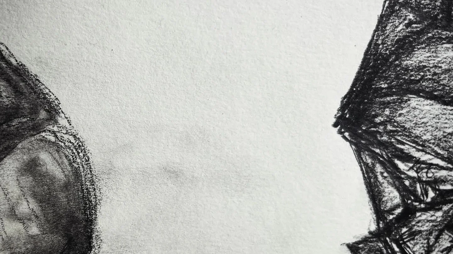Close-up black and white sketch of a person's face and hand with their head bowed, viewed from the side.