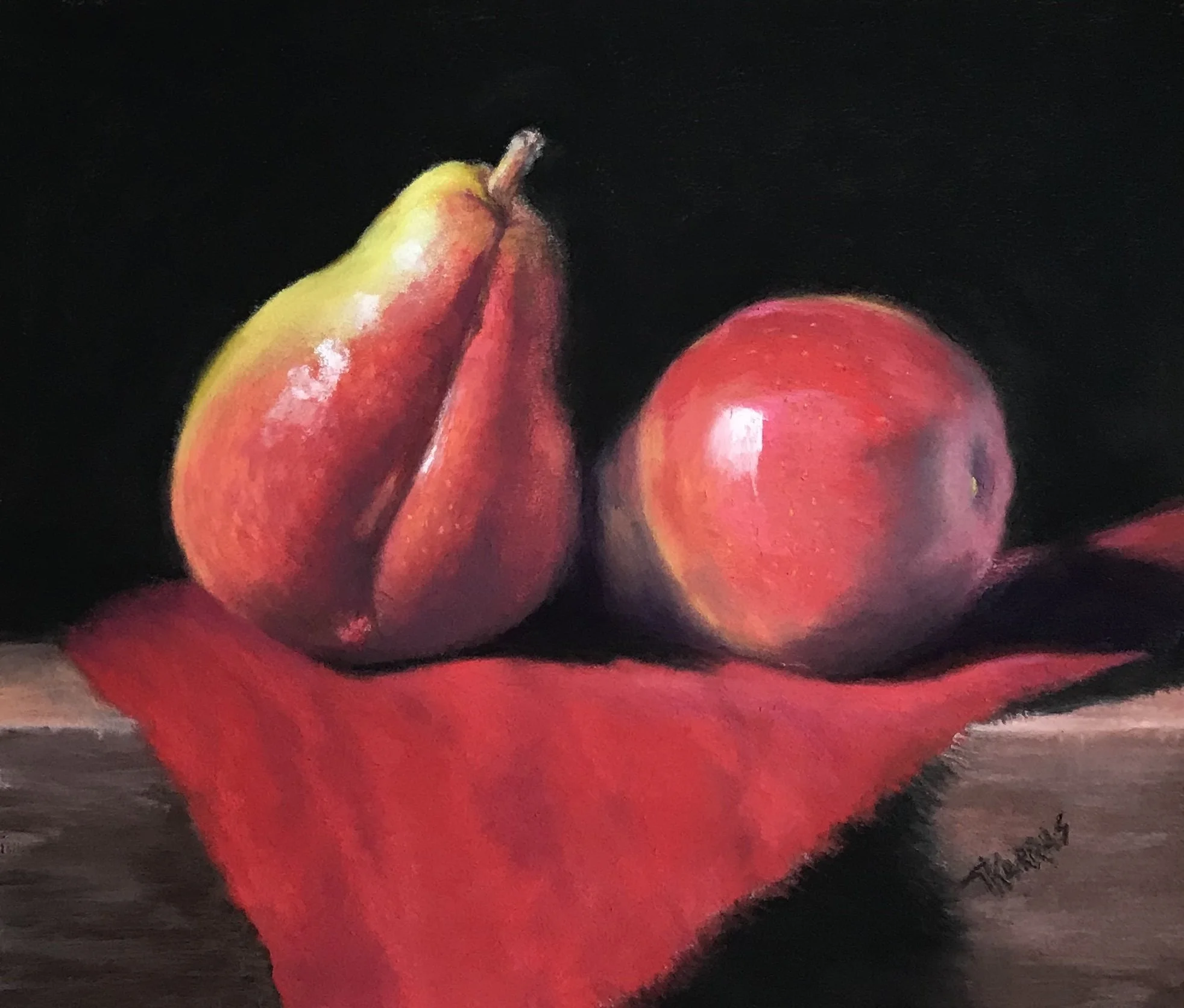 Close-up of a pear and an apple on a dark surface with a dark background.