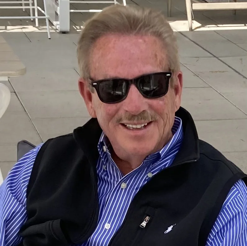 smiling man in blue striped shirt