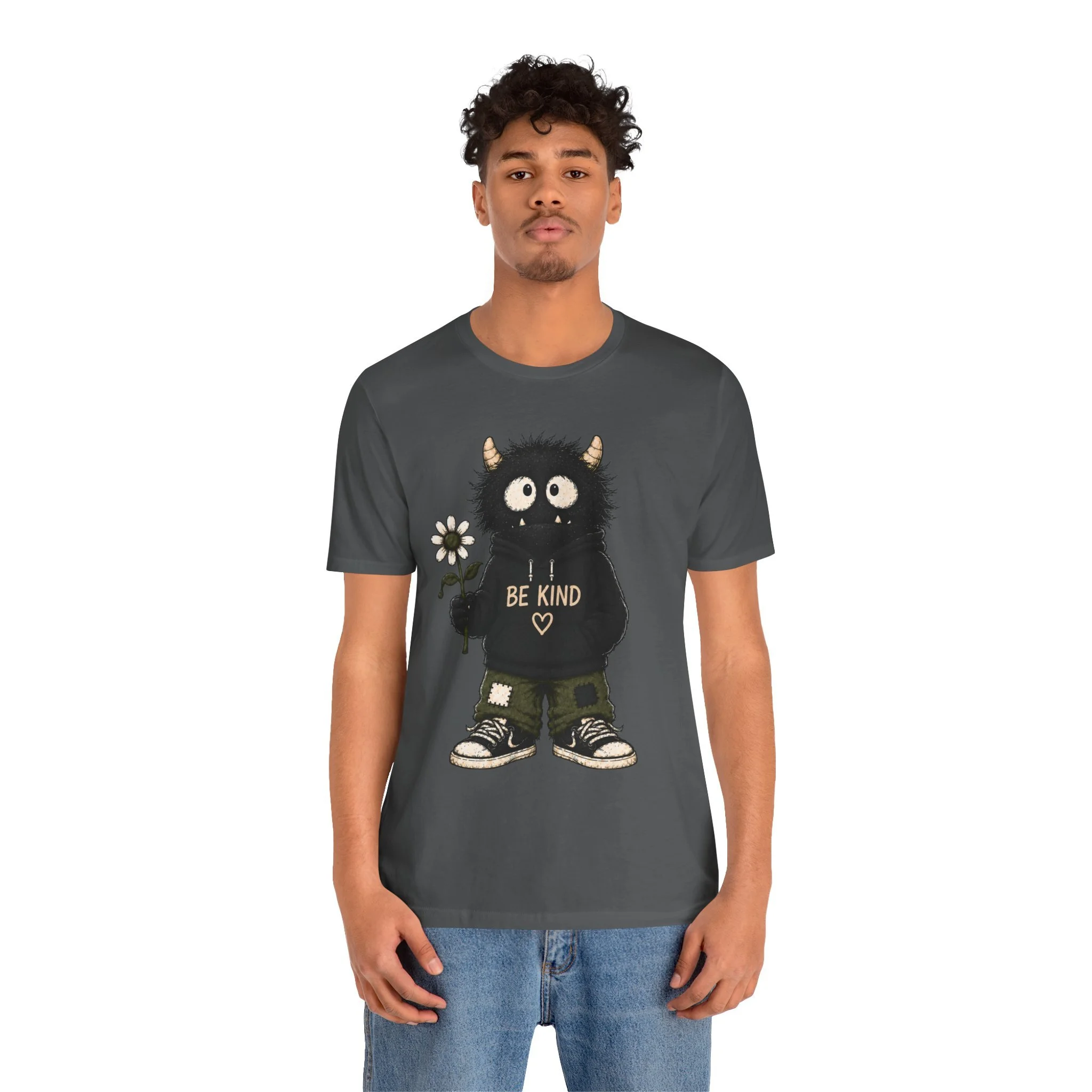 Second model wearing the charcoal Be Kind monster graphic T-shirt, shown from the front.