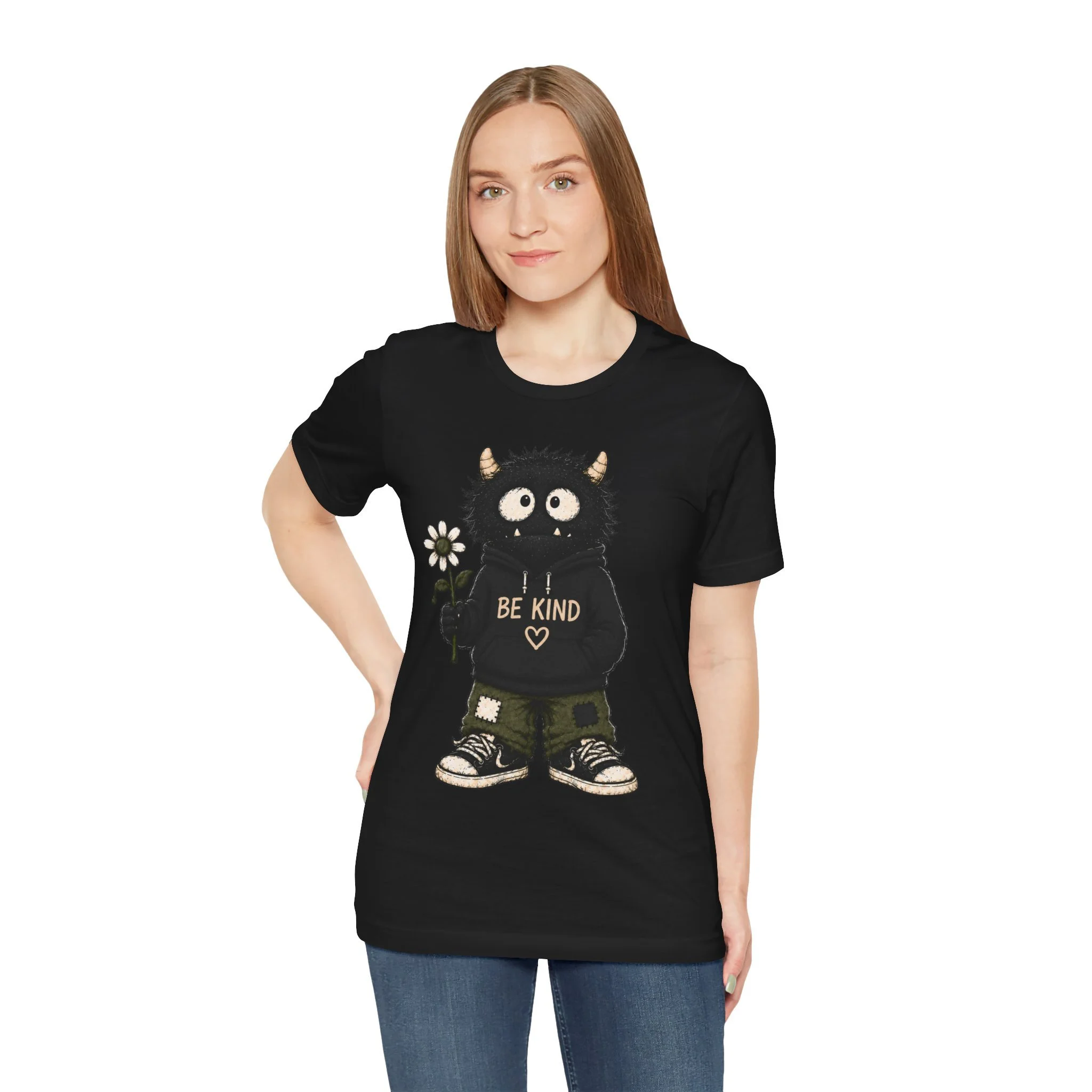 Model wearing the black Be Kind monster graphic T-shirt, shown from the front.