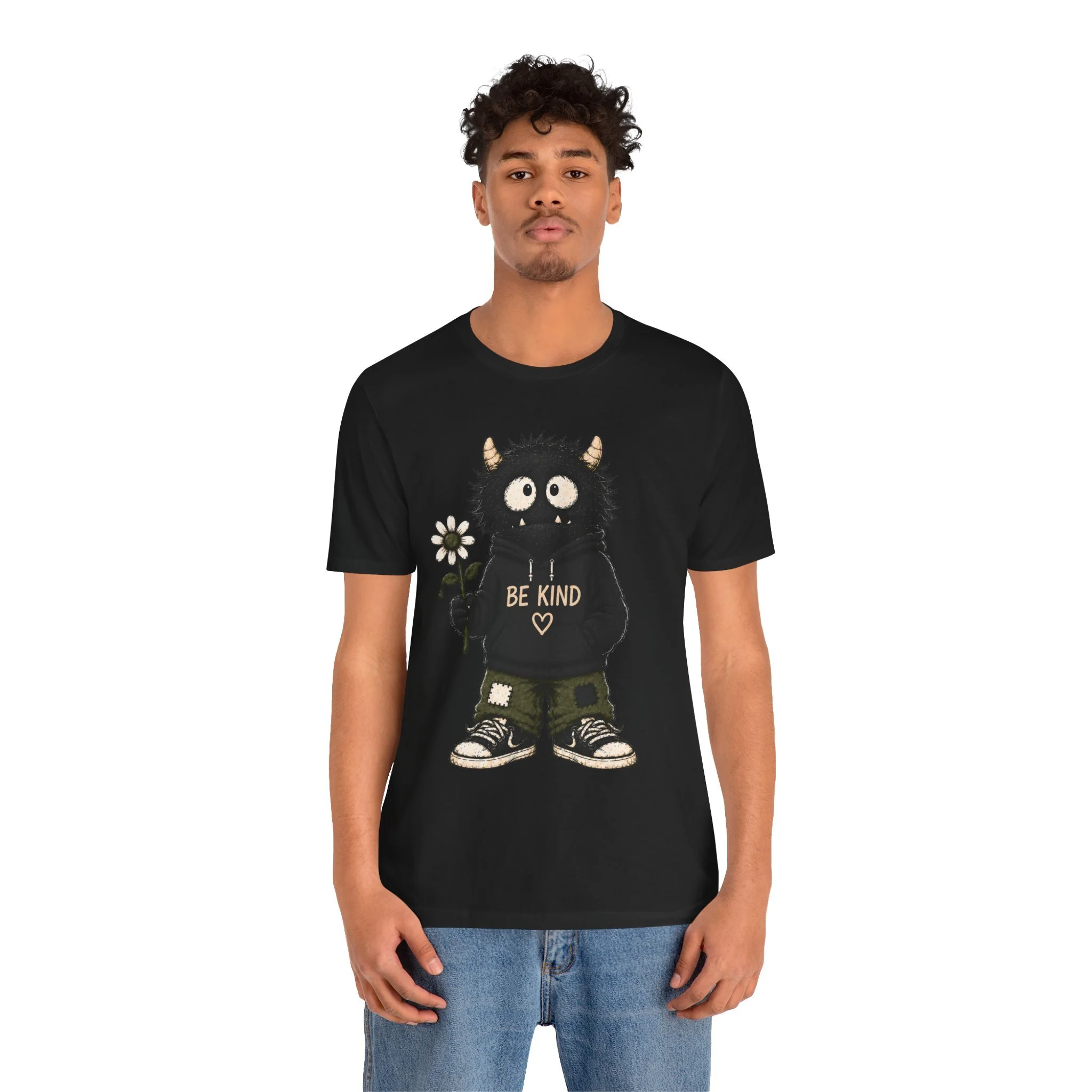 Second model wearing the black Be Kind monster graphic T-shirt, shown from the front.
