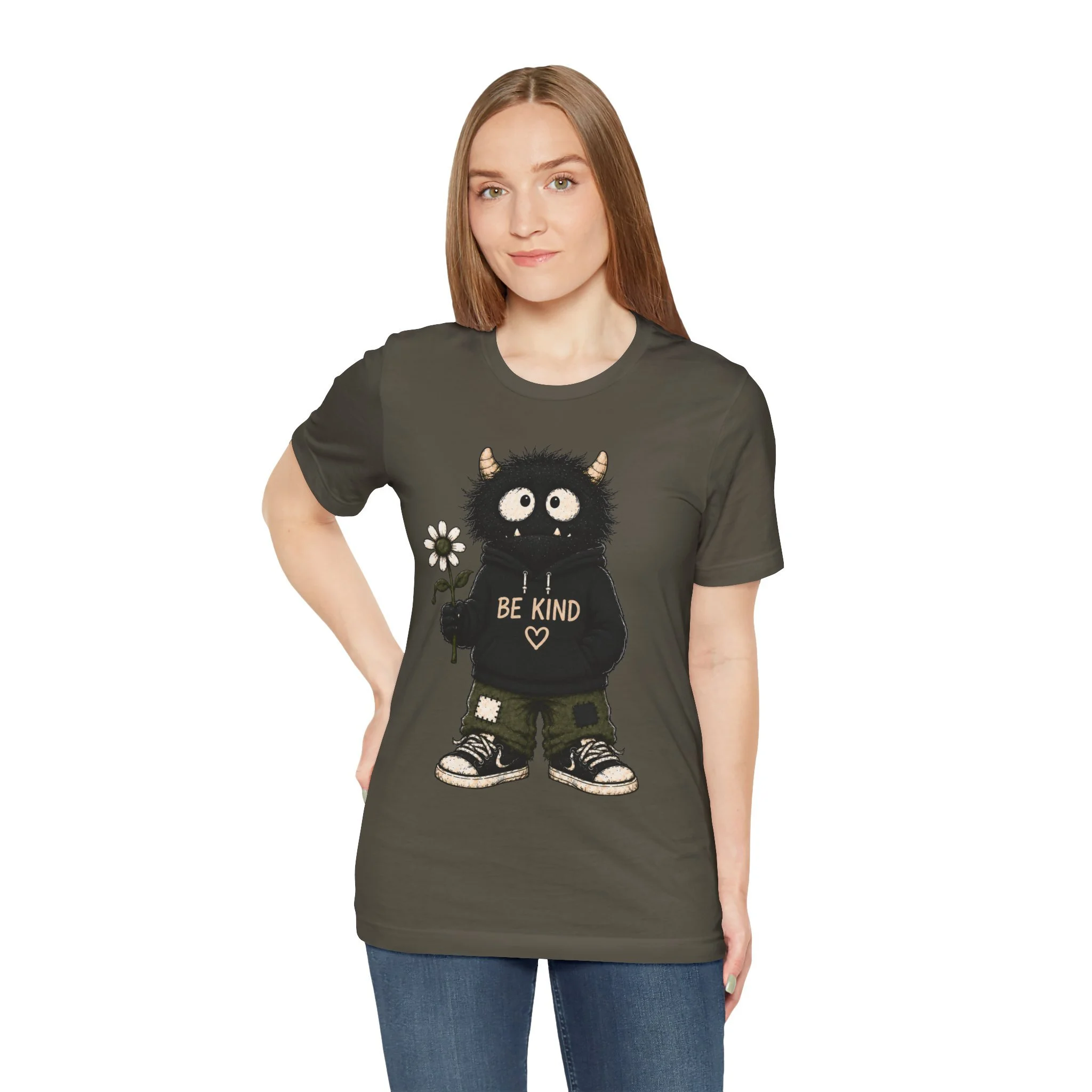 Model wearing the olive-colored Be Kind monster graphic T-shirt, shown from the front.