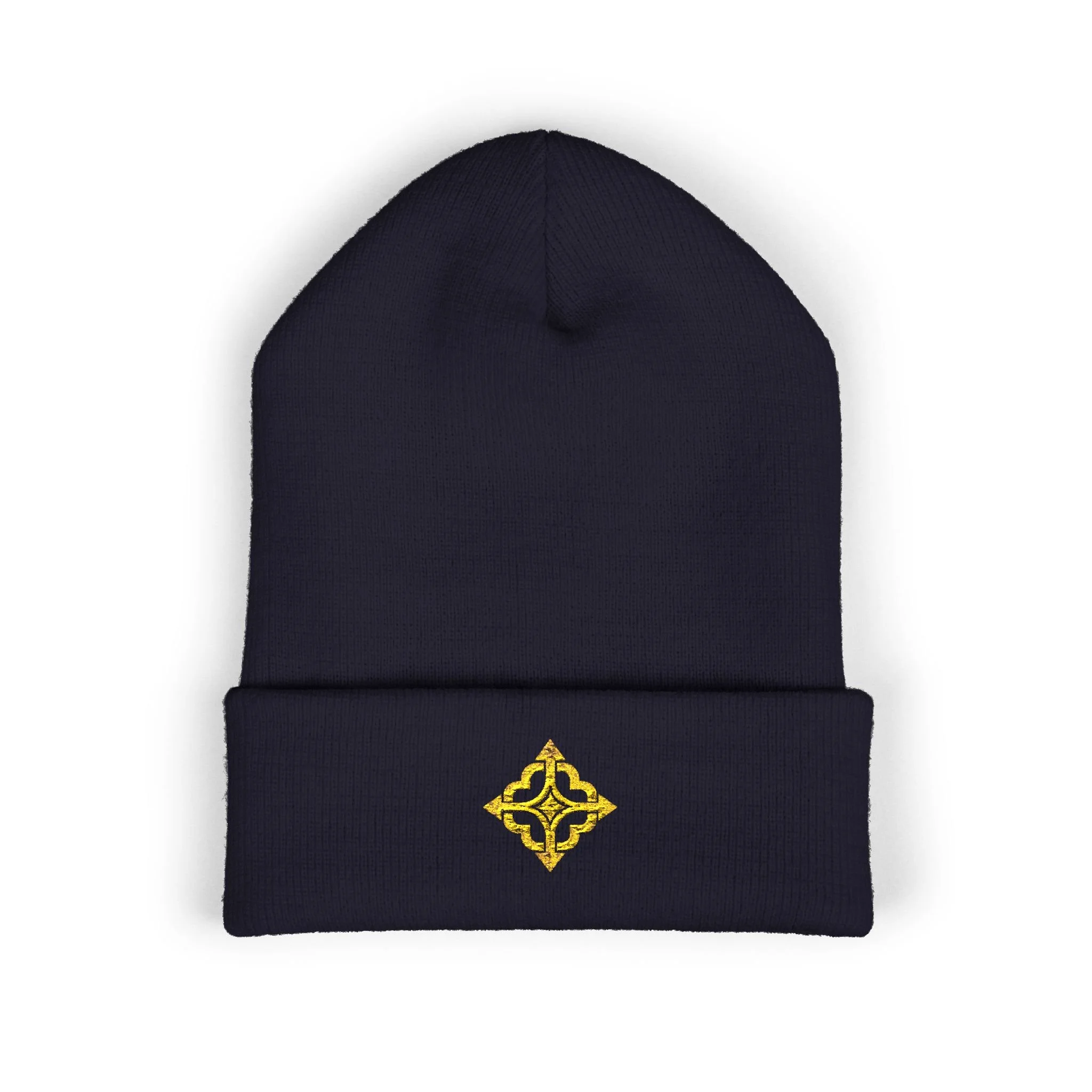 Front of the navy Quiet Compass knit beanie with a gold four-path compass embroidered on the folded cuff.