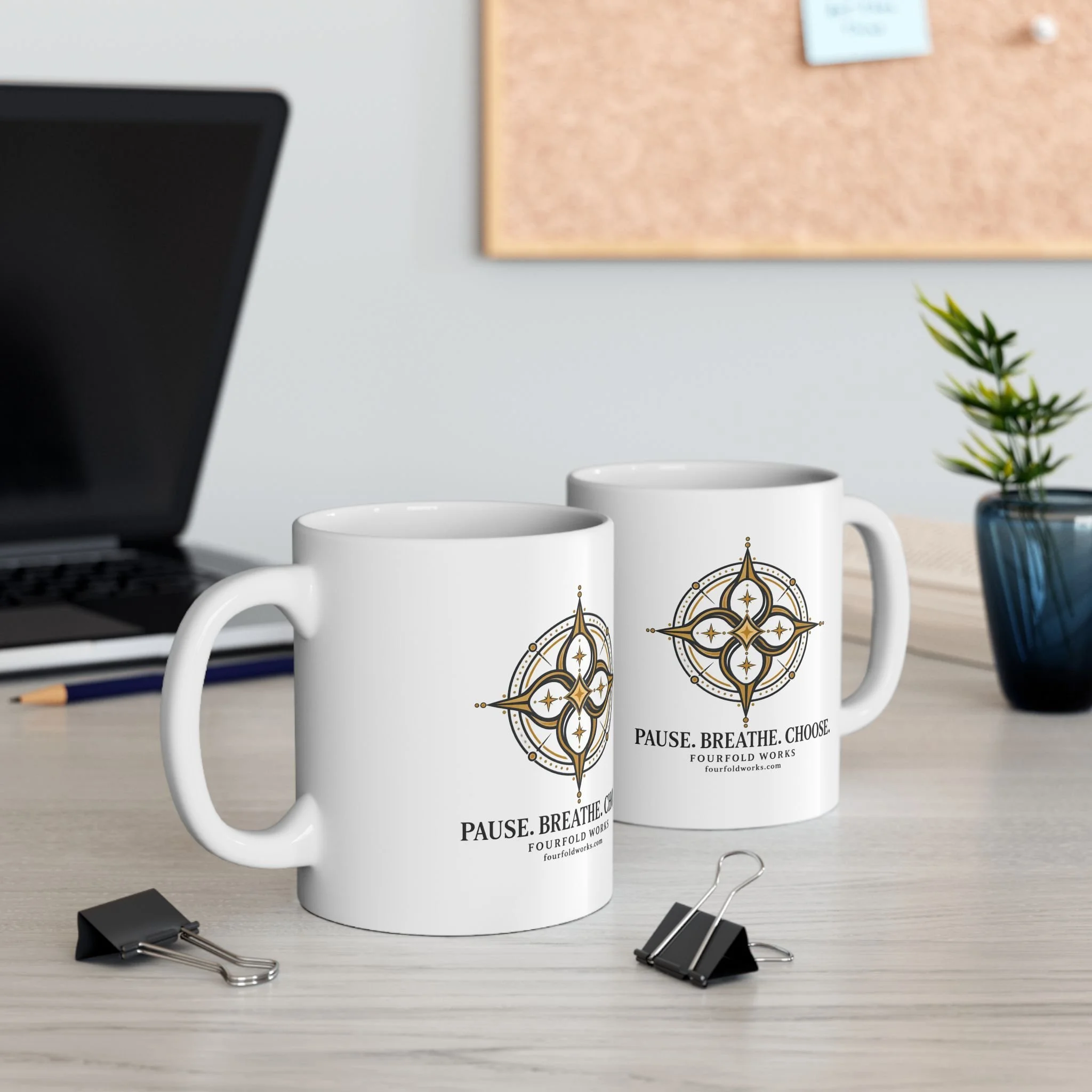 Two Pause. Breathe. Choose. mugs on a desk beside a laptop and small plant.