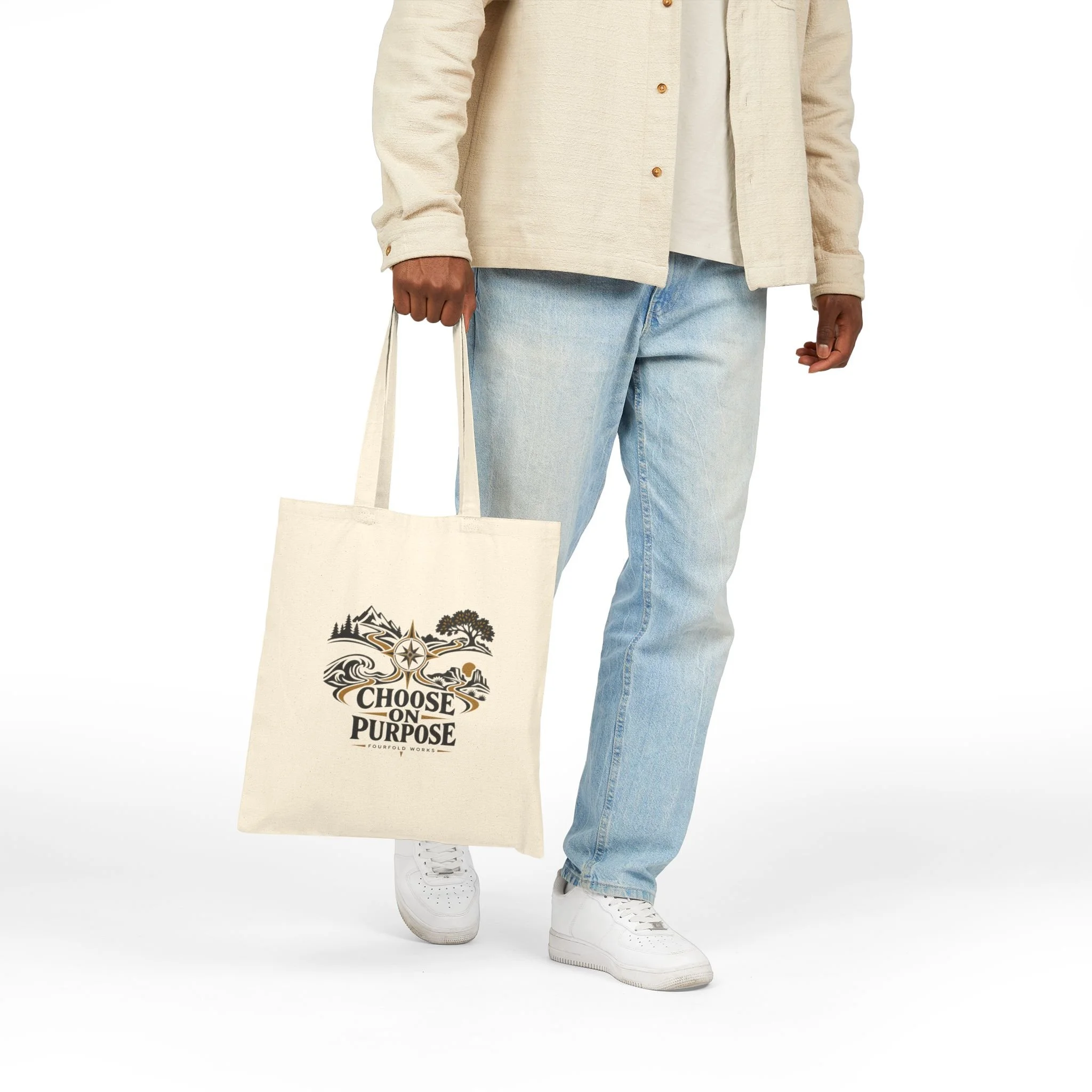 Standing model holding the Choose on Purpose canvas tote by its handles, showing the front graphic.