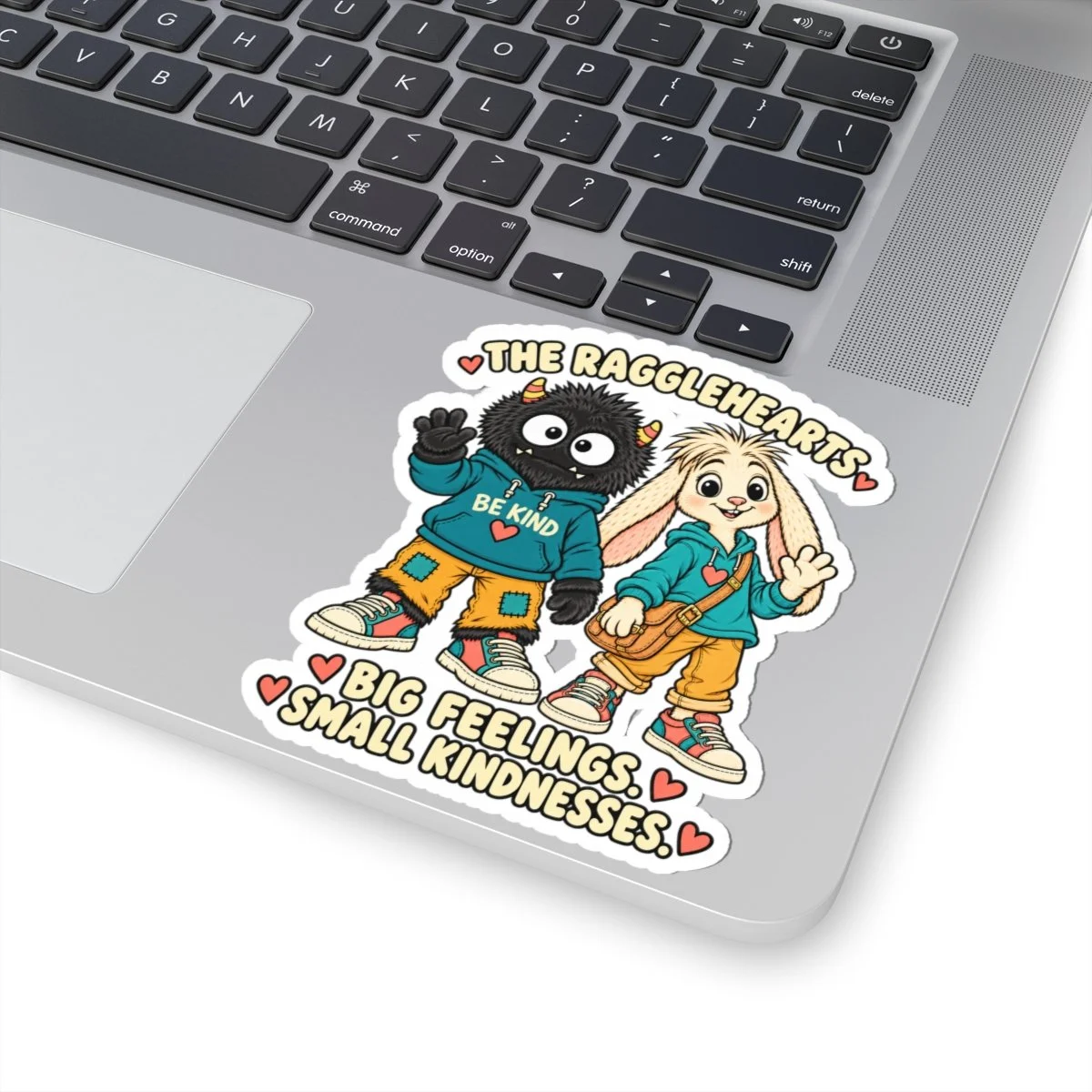 Big Feelings. Small Kindnesses. duo sticker applied to a laptop palm rest.