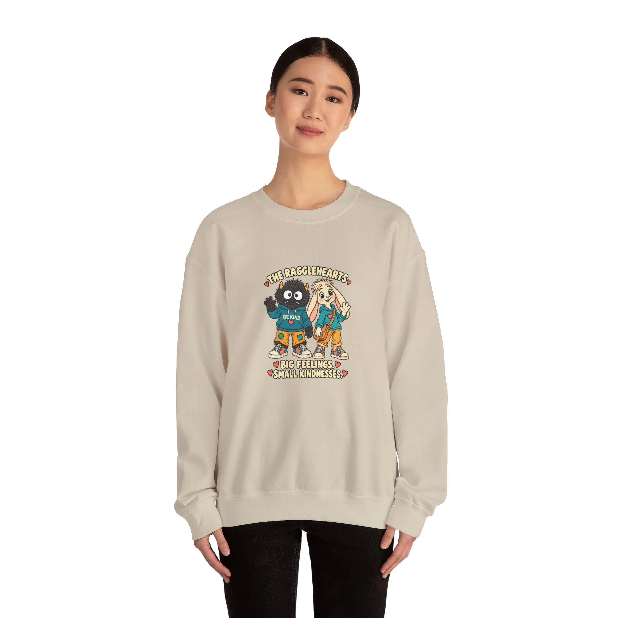 Model wearing the sand-colored Big Feelings. Small Kindnesses. sweatshirt, shown from the front.