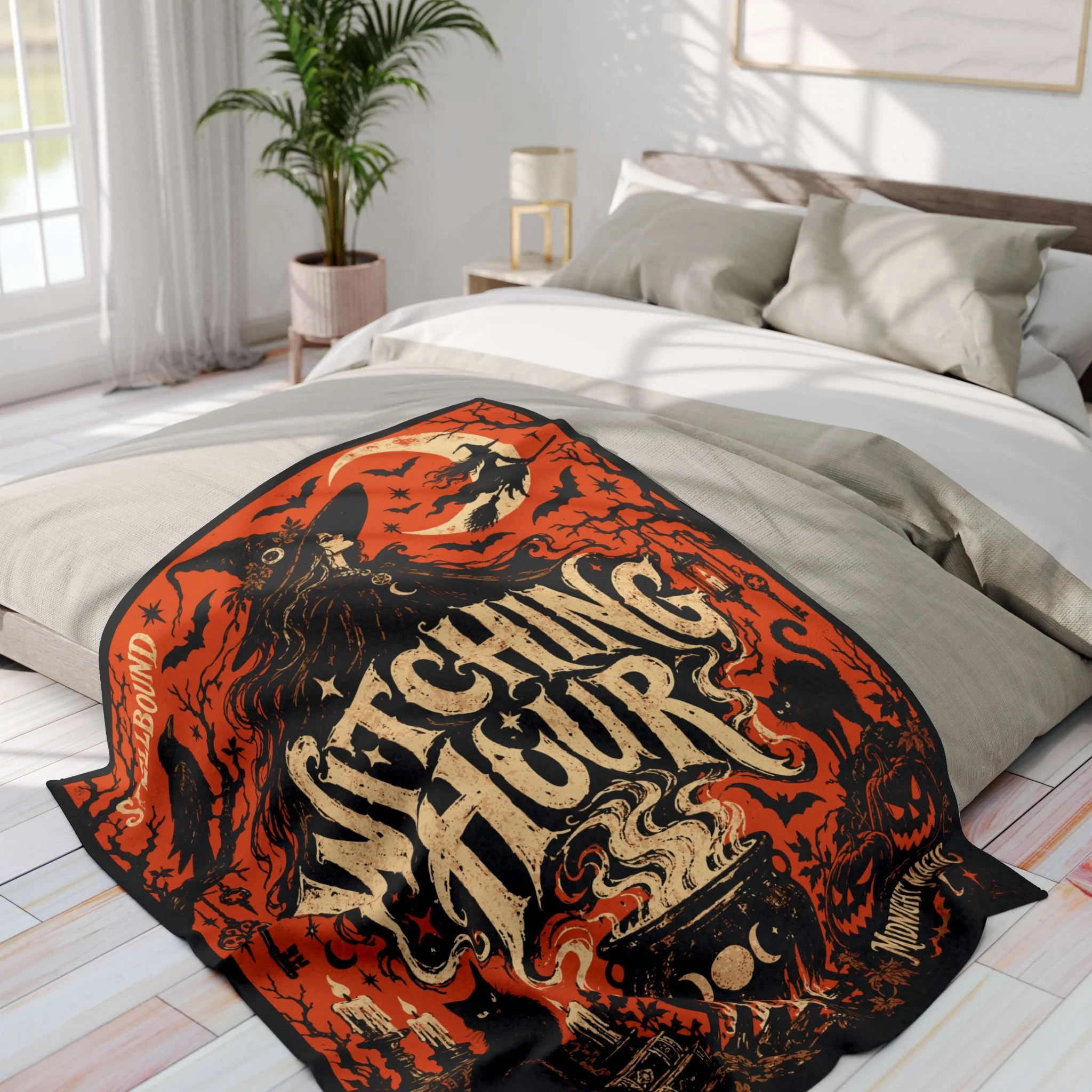 Bedroom view of the Witching Hour fleece blanket spread across a bed, showing its complete printed design.