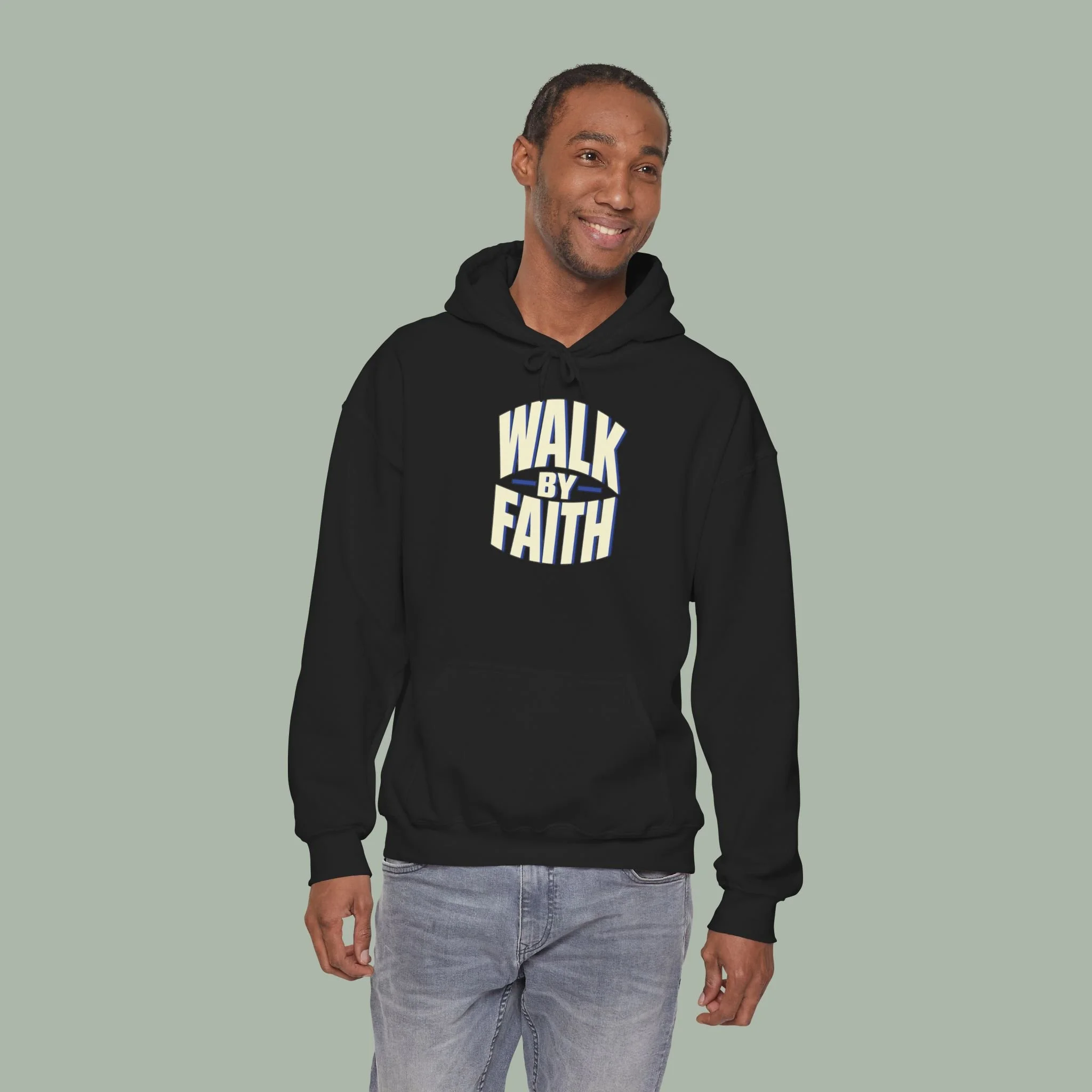 Standing model wearing Black Walk by Faith hoodie with the original ivory and cobalt front lettering