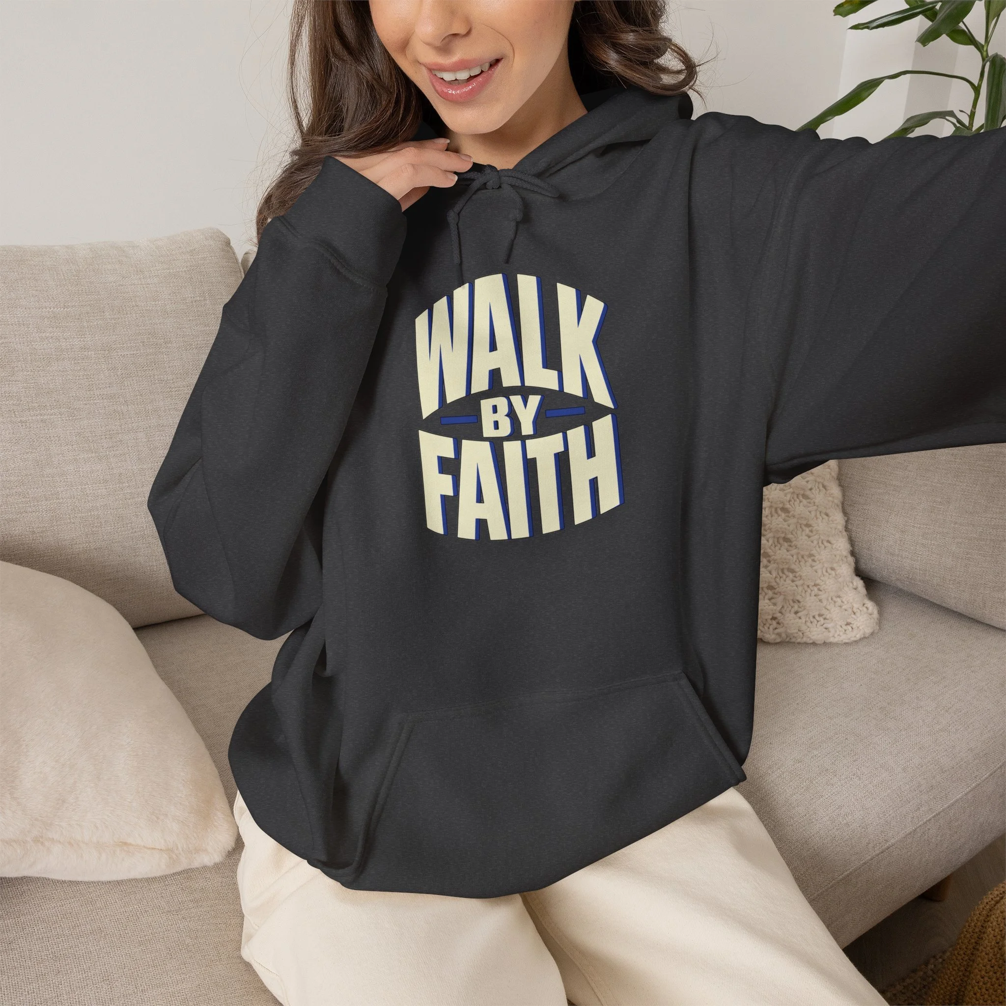 Seated model wearing Dark Heather Walk by Faith hoodie, front view