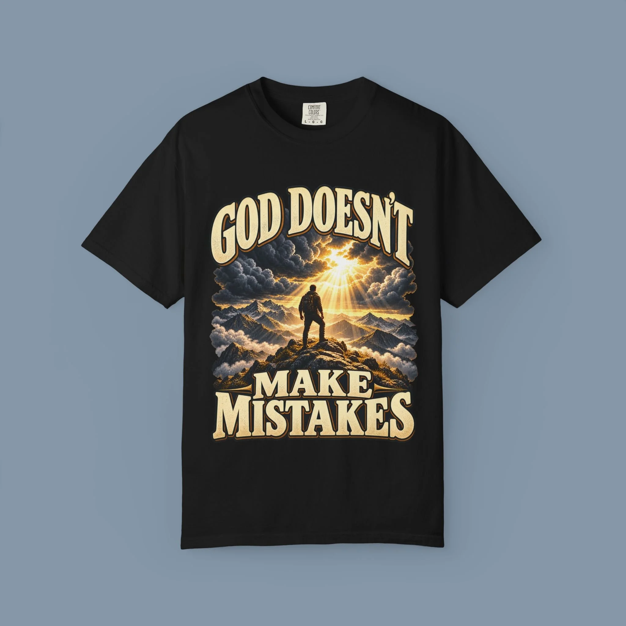 Black God Doesn’t Make Mistakes tee with complete mountain and golden-light front artwork