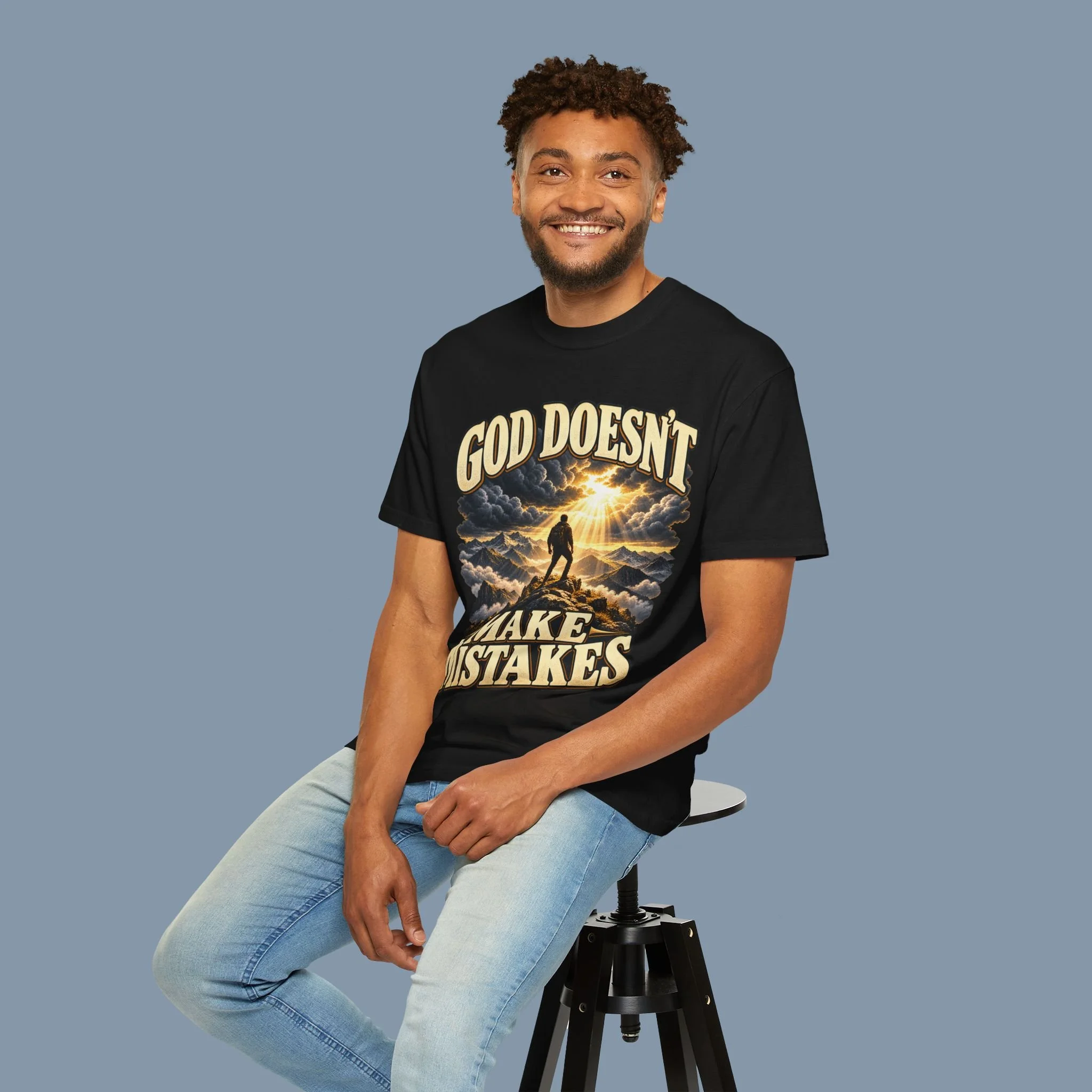 Seated model wearing Black God Doesn’t Make Mistakes tee