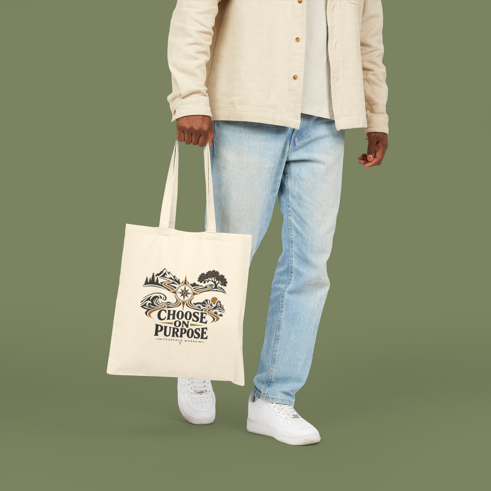 Natural Choose on Purpose canvas tote carried by a model against the approved medium olive background, with the full compass artwork and wording visible.
