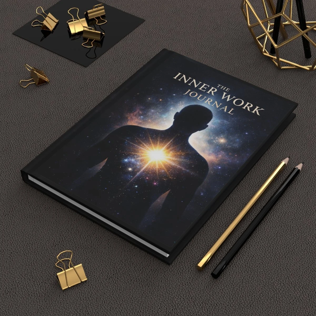 Inner Work glowing figure lined journal on a charcoal desk with gold stationery.