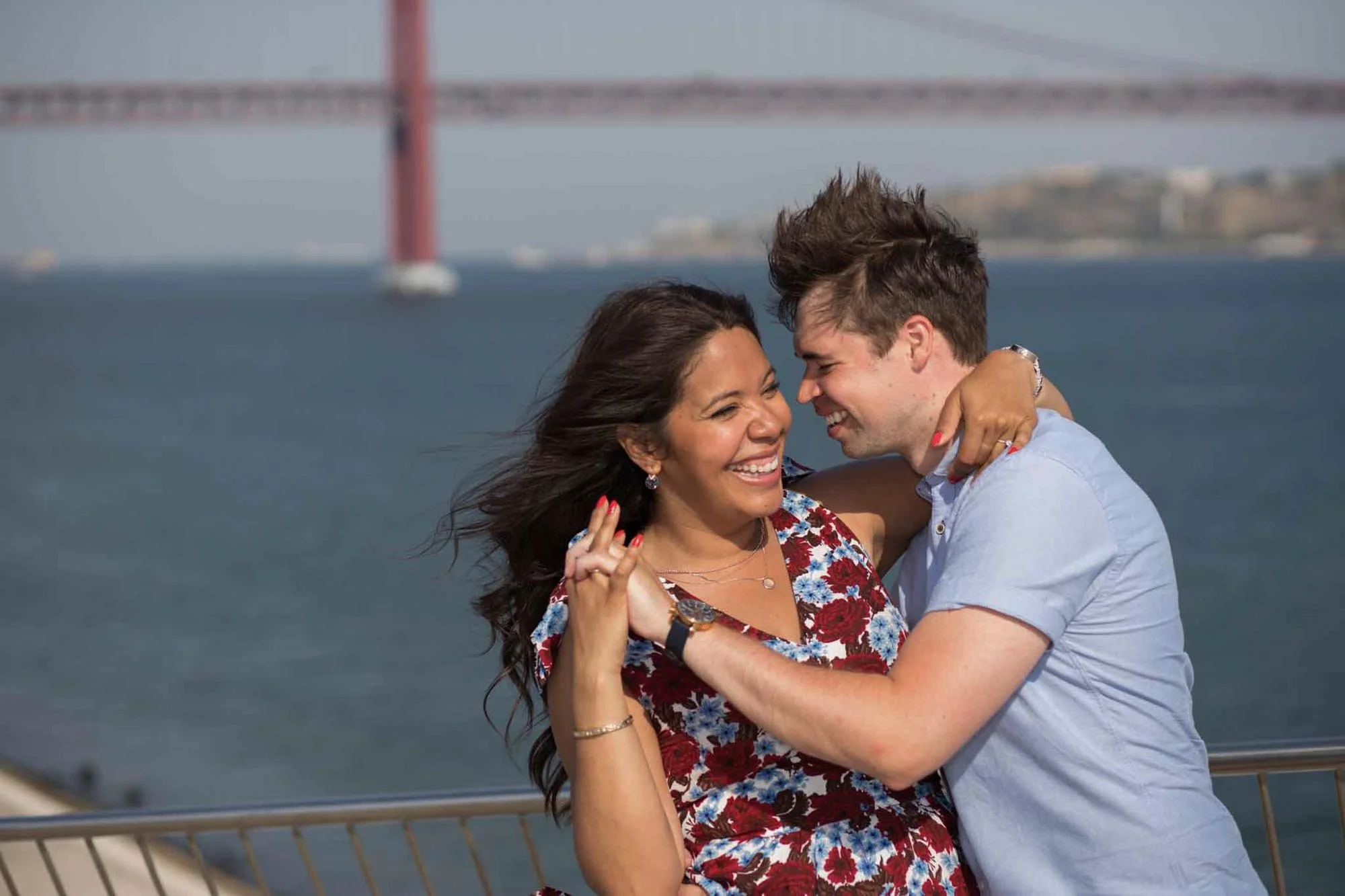 Happy couple smiling after secret proposal photoshoot in Belem area, Lisbon.