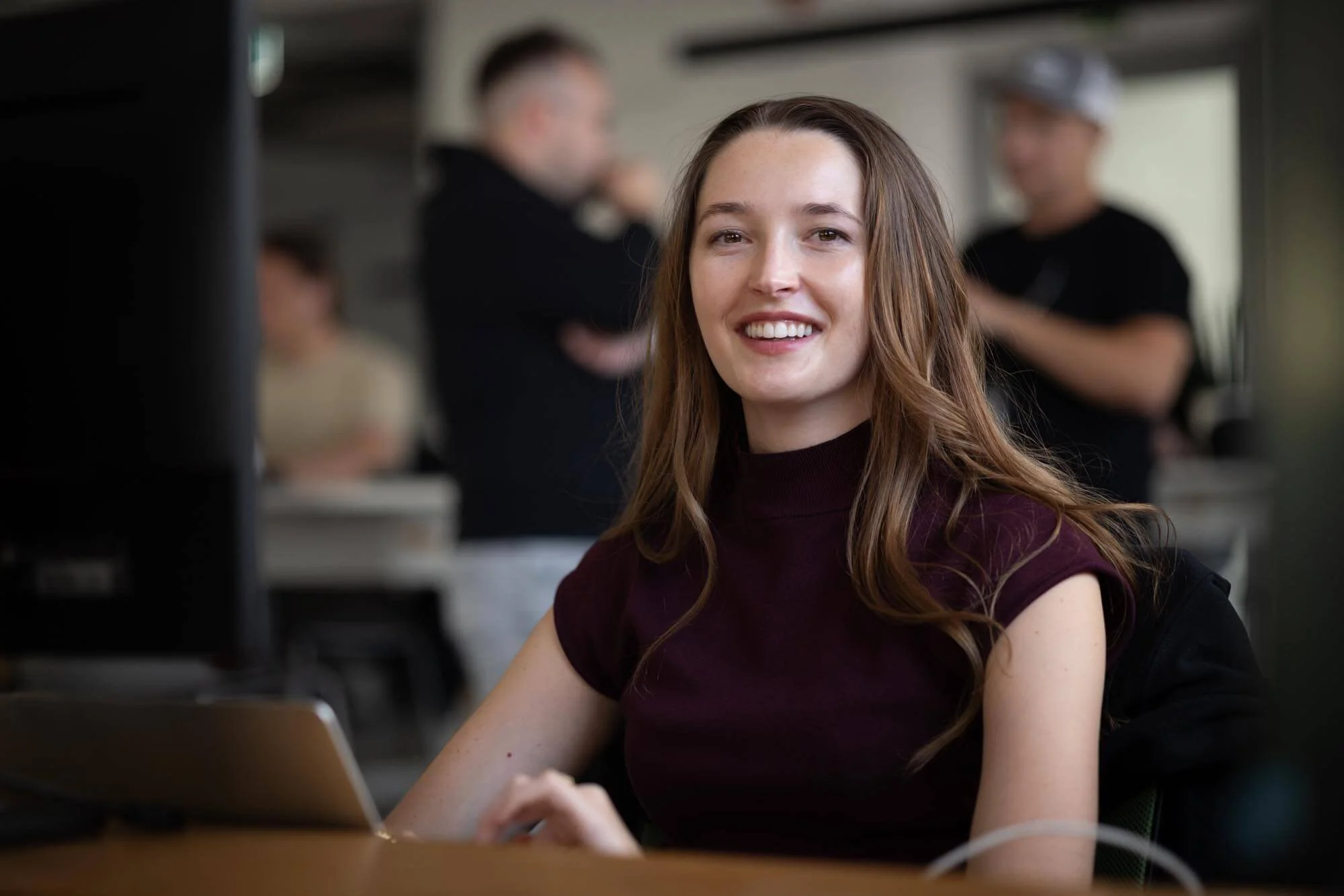 Startup offsite photography. Portrait of a young woman sitting at the desk.