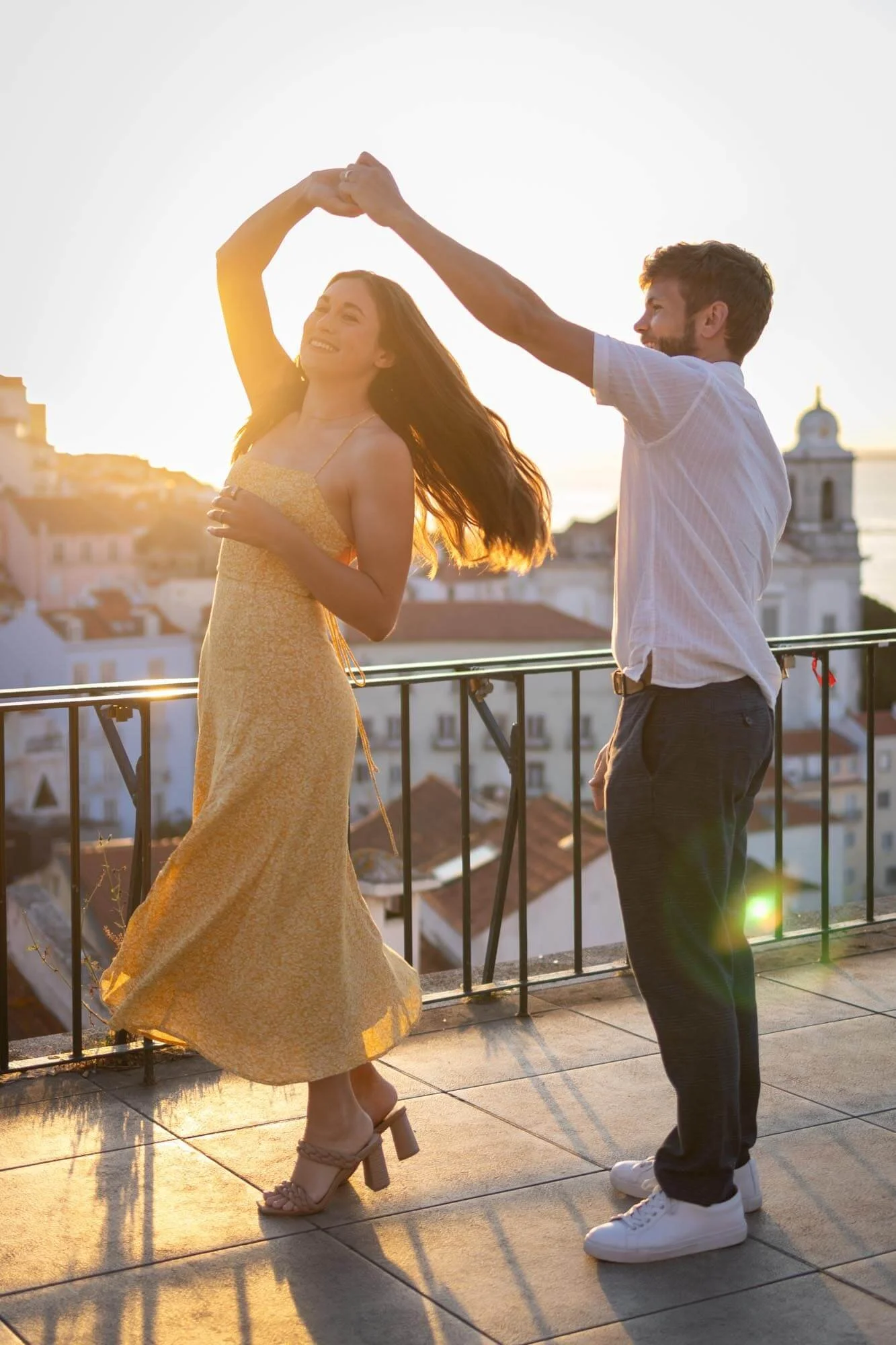 A couple photoshoot at Alfama viewpoint with a beautiful couple dancing at the sunrise. 