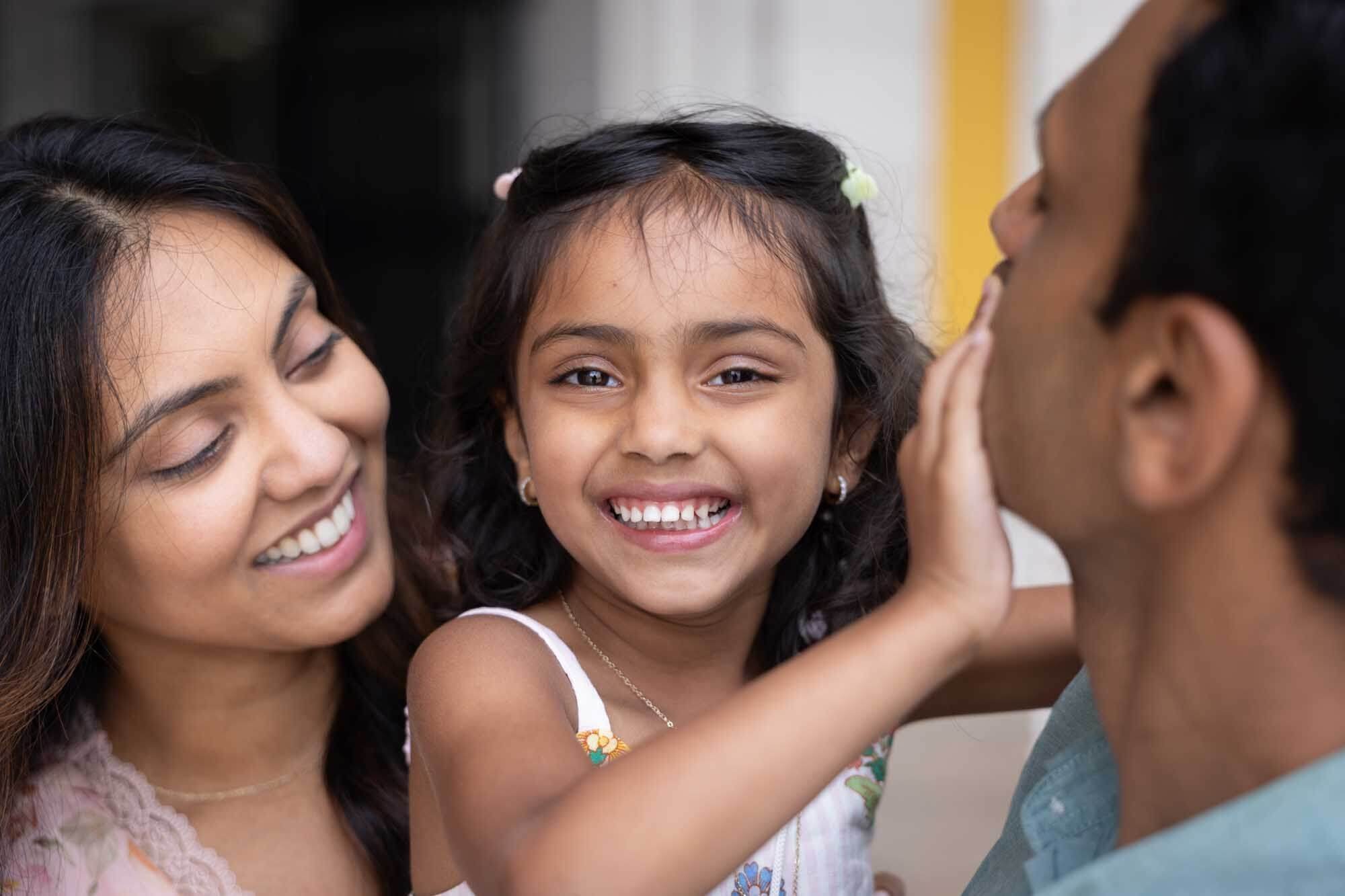 A young family hugging, during a Lisbon photoshoot.