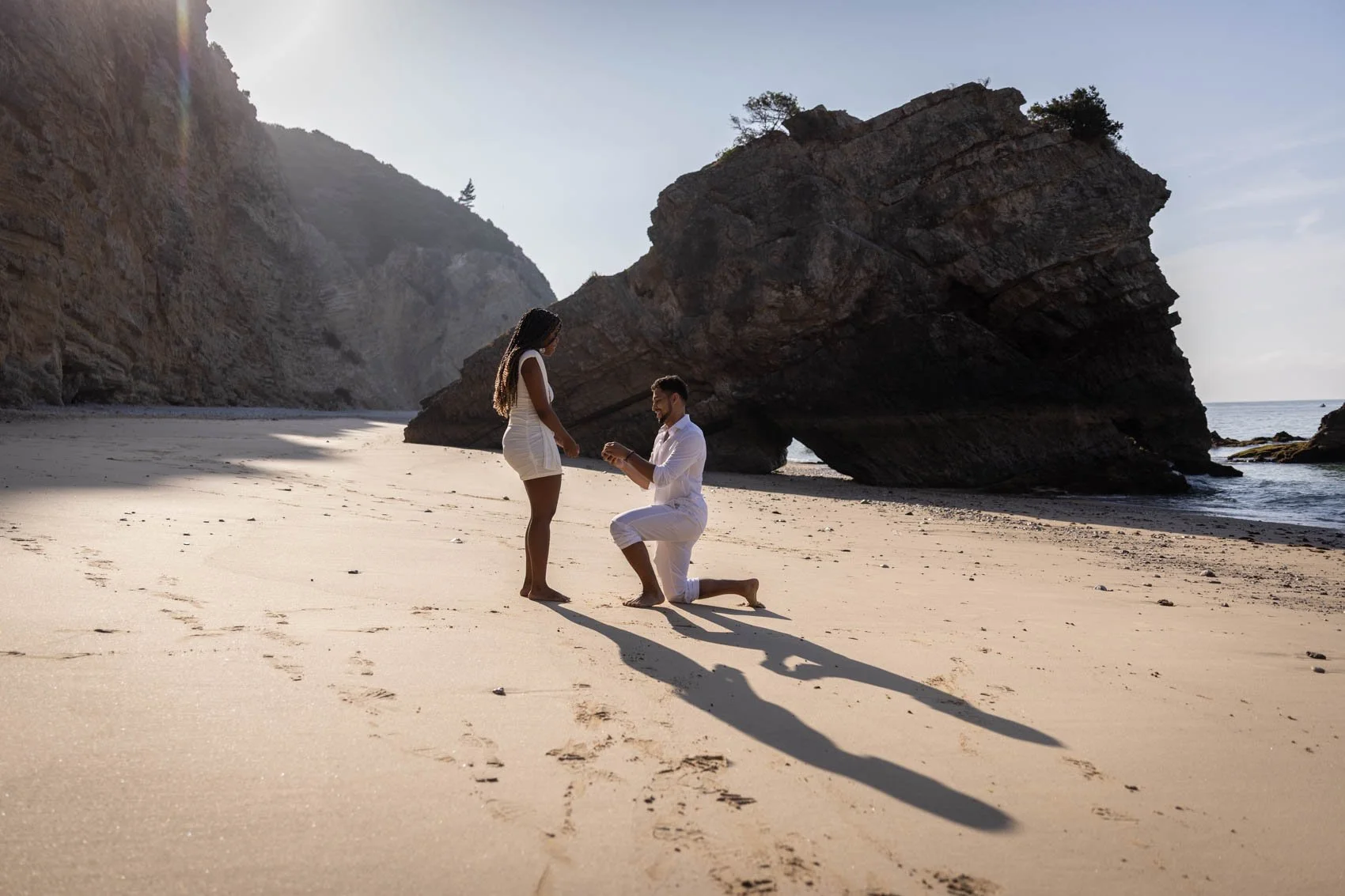Secret Proposal at Ribeira de Cavalo beach with beautiful couple in white at secluded Sesimbra beach.