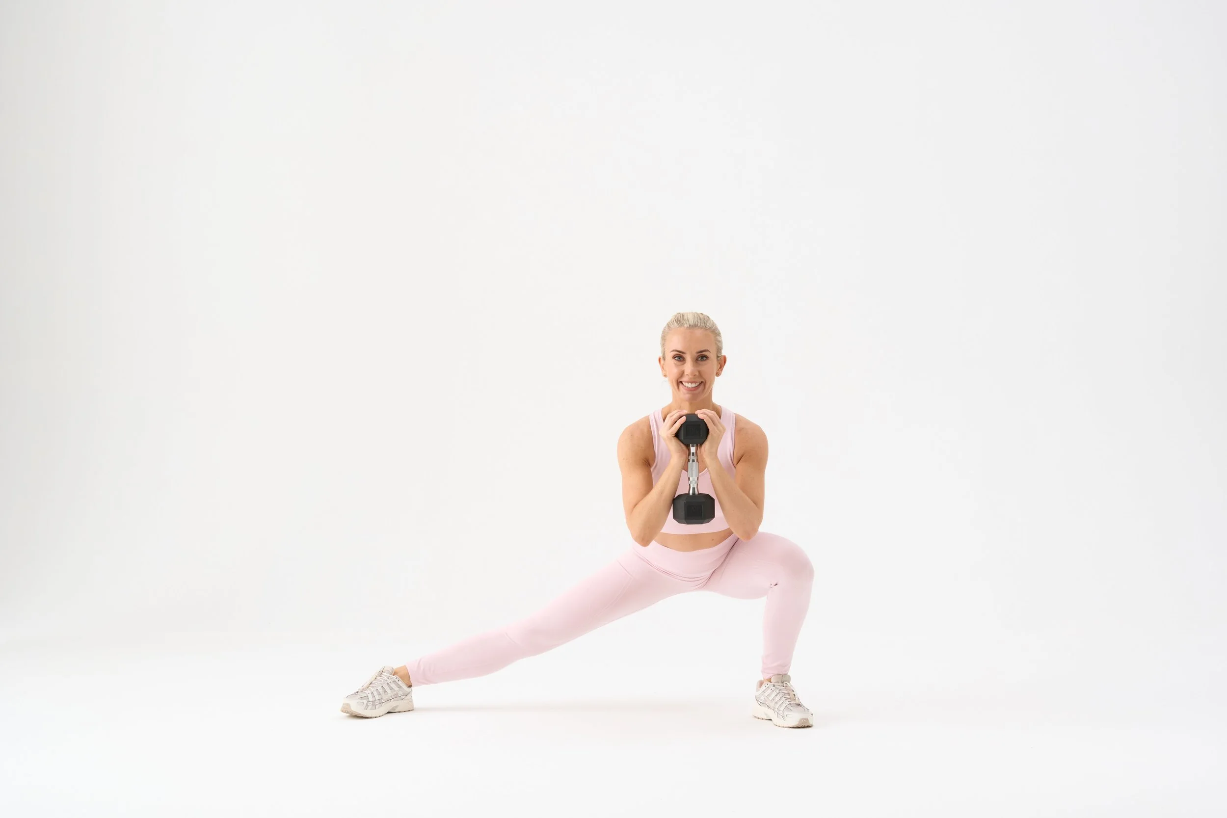 Kelly holding dumbbell