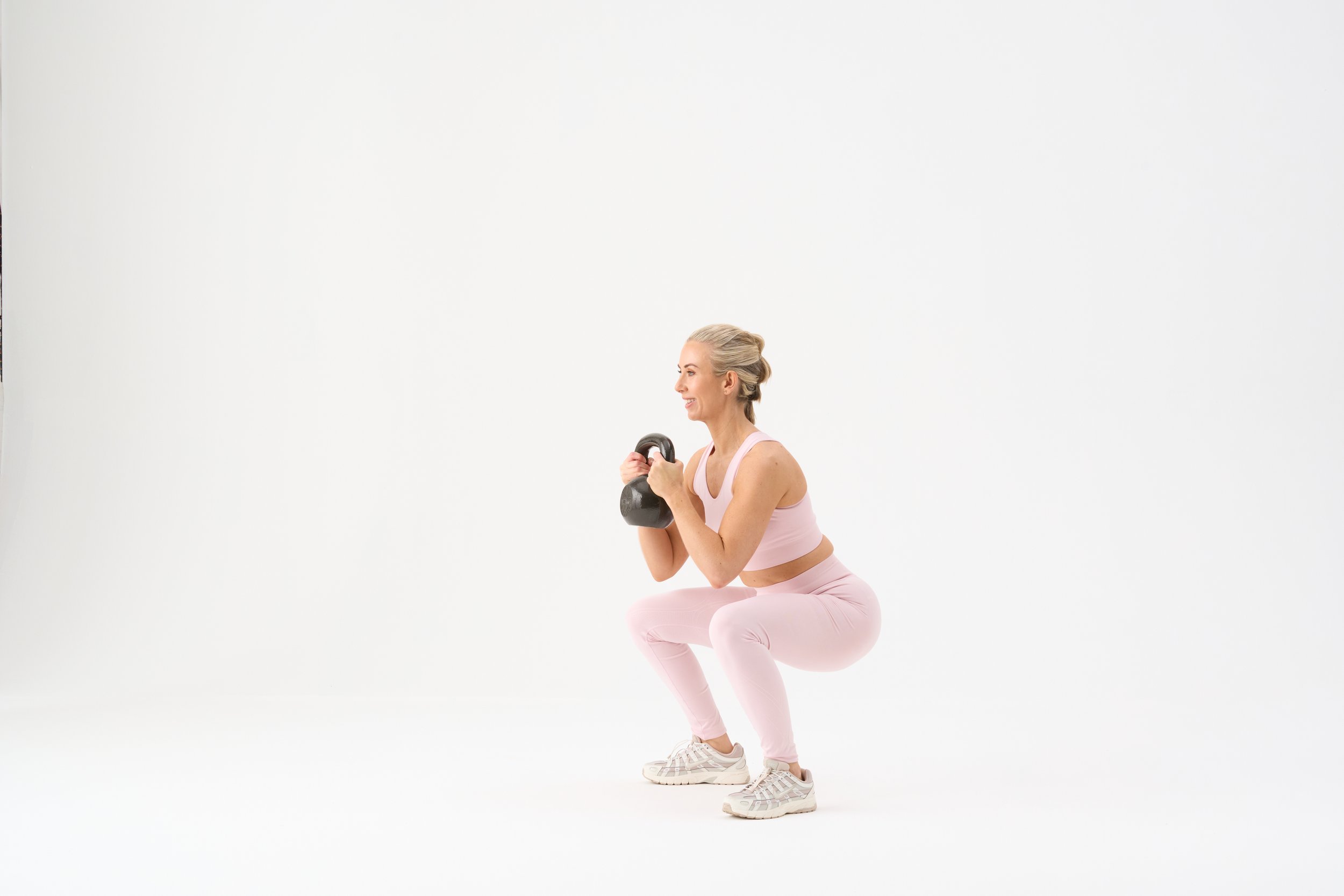 Kelly holding dumbbells