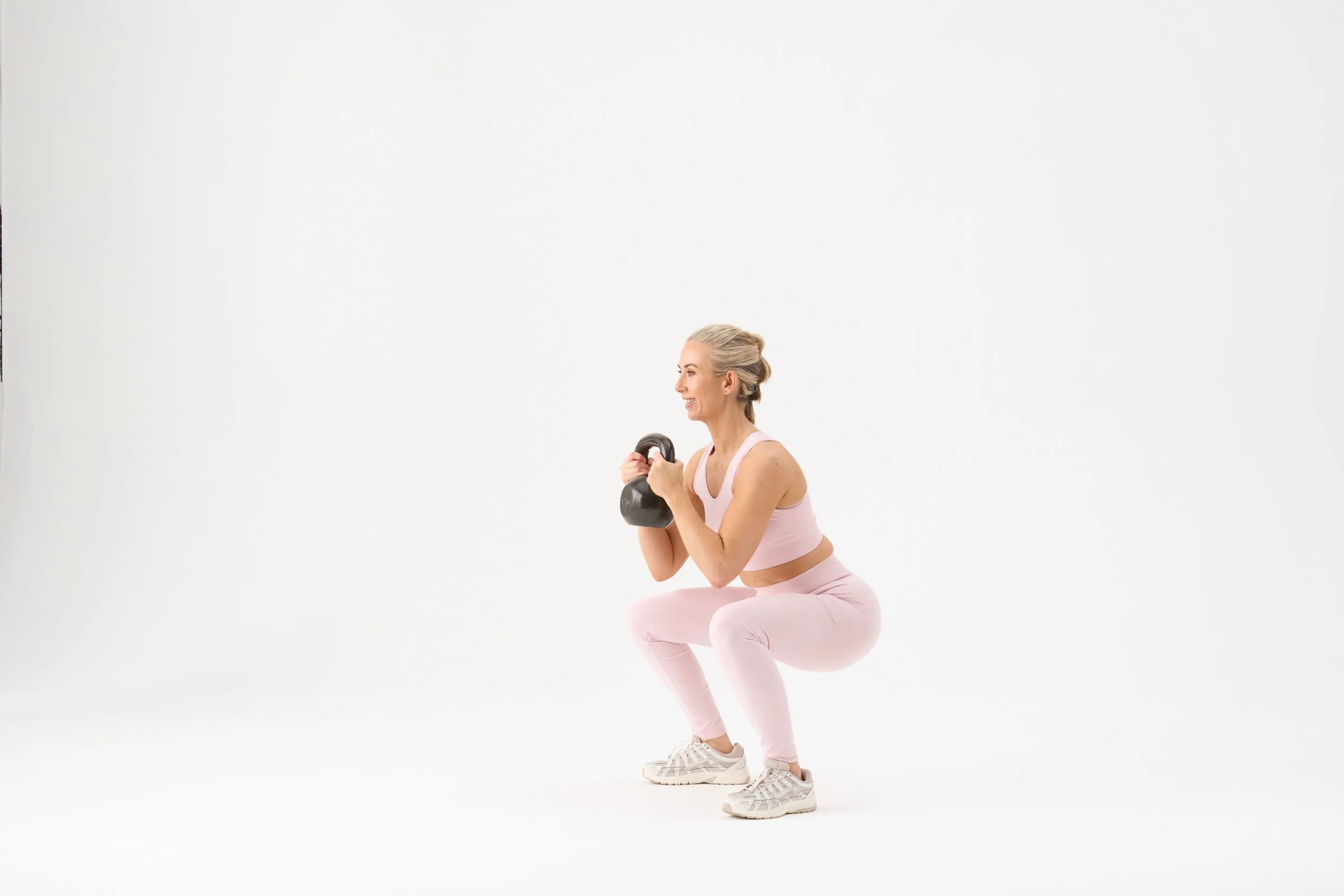 Kelly holding dumbbells