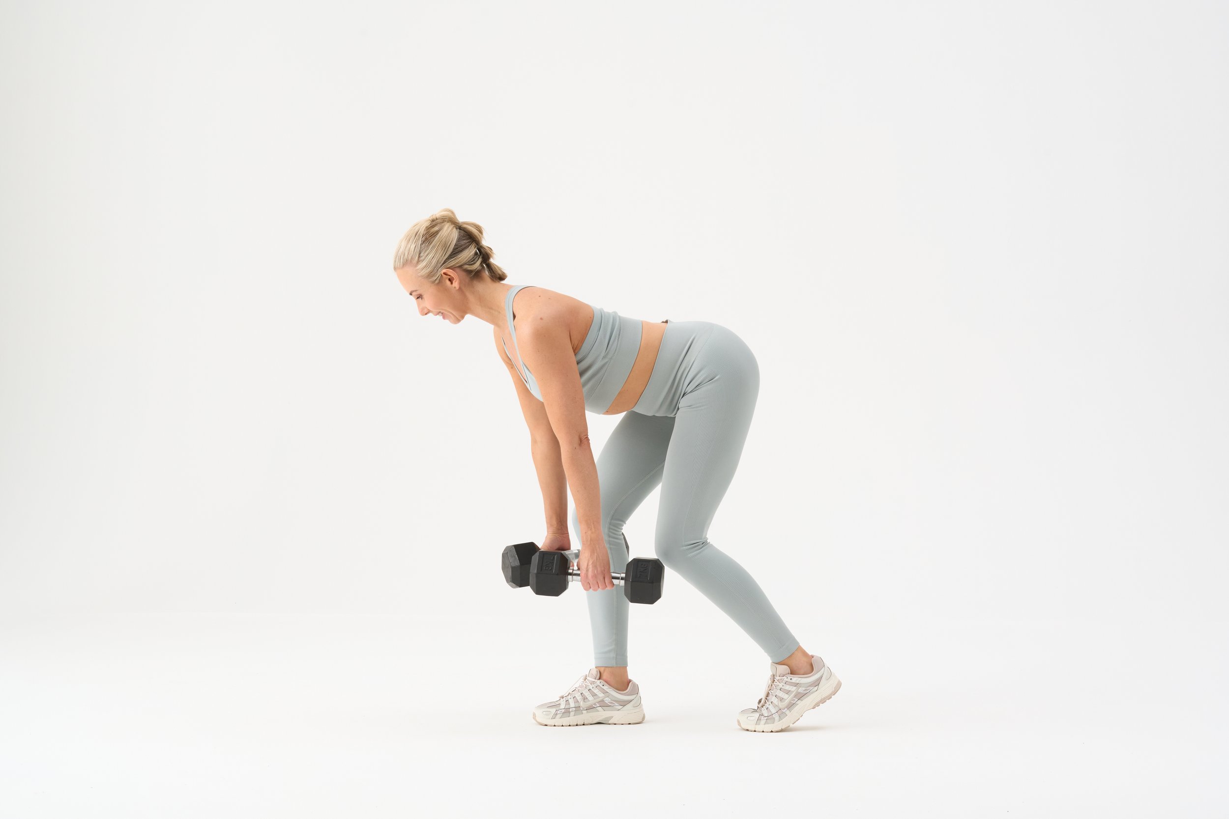 Kelly holding dumbbells