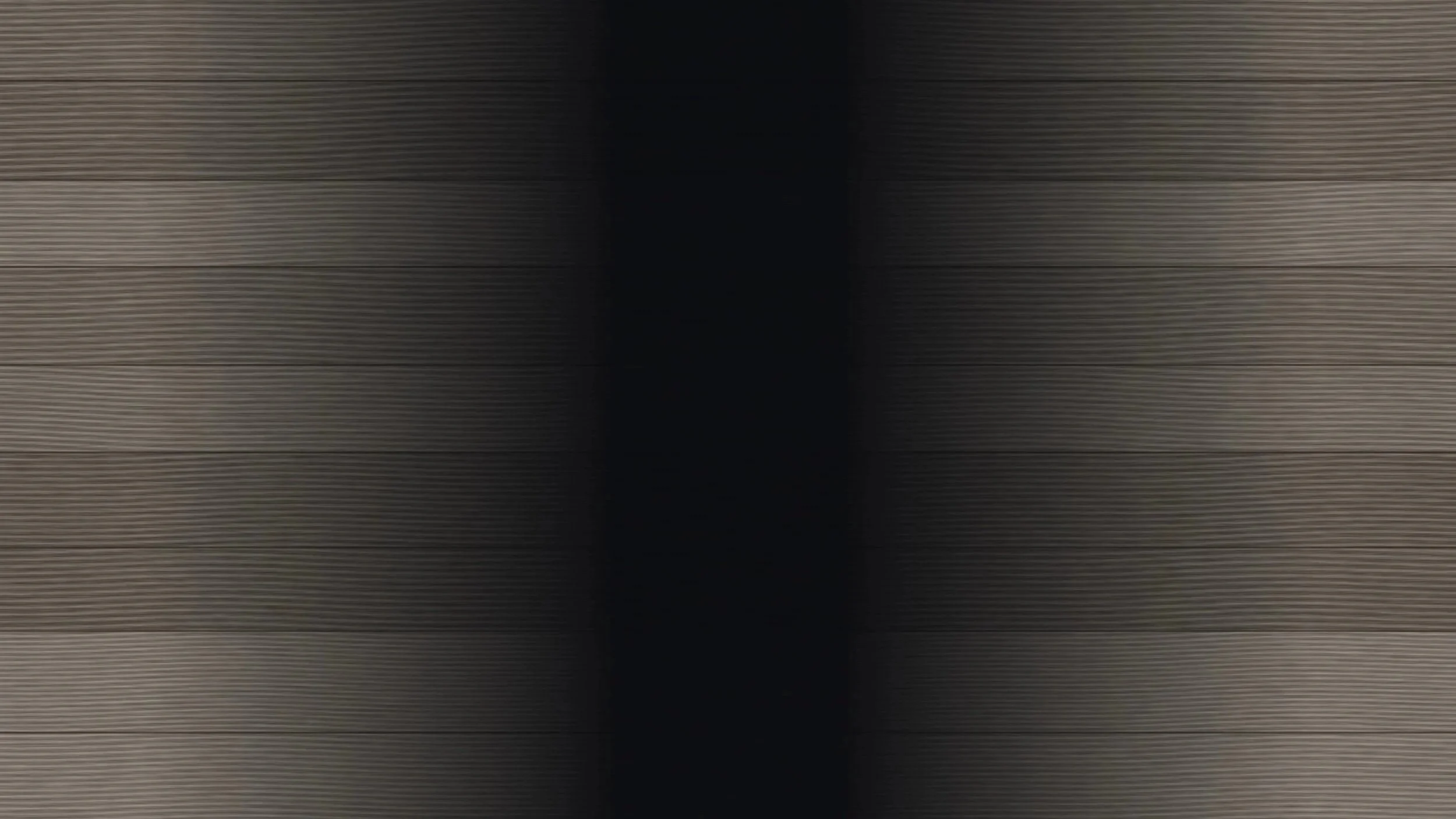 Close-up view of wooden paneling with horizontal lines and a dark vertical strip in the center.